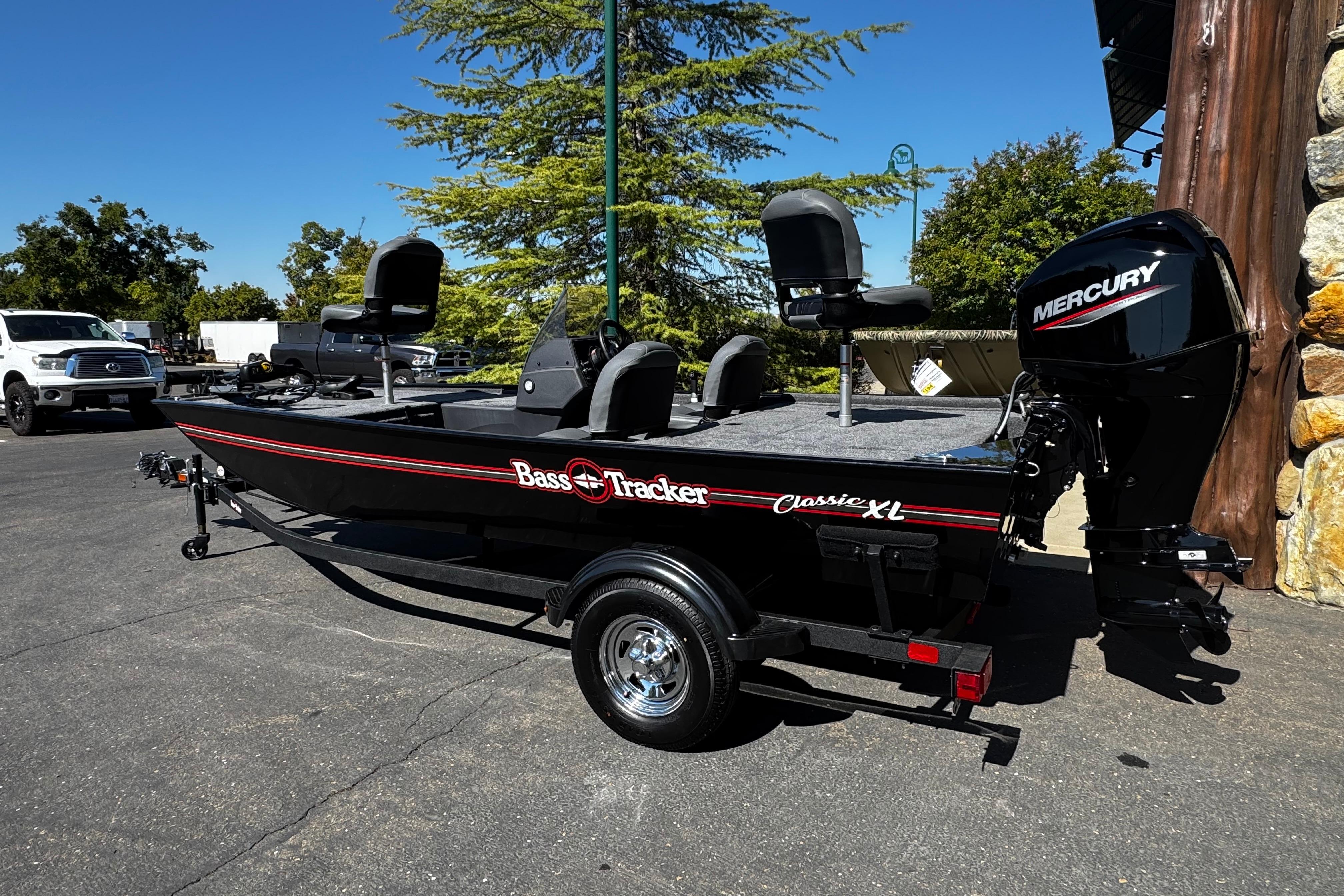 2026 Tracker Bass Tracker Classic XL boat with Mercury engine, parked outdoors.