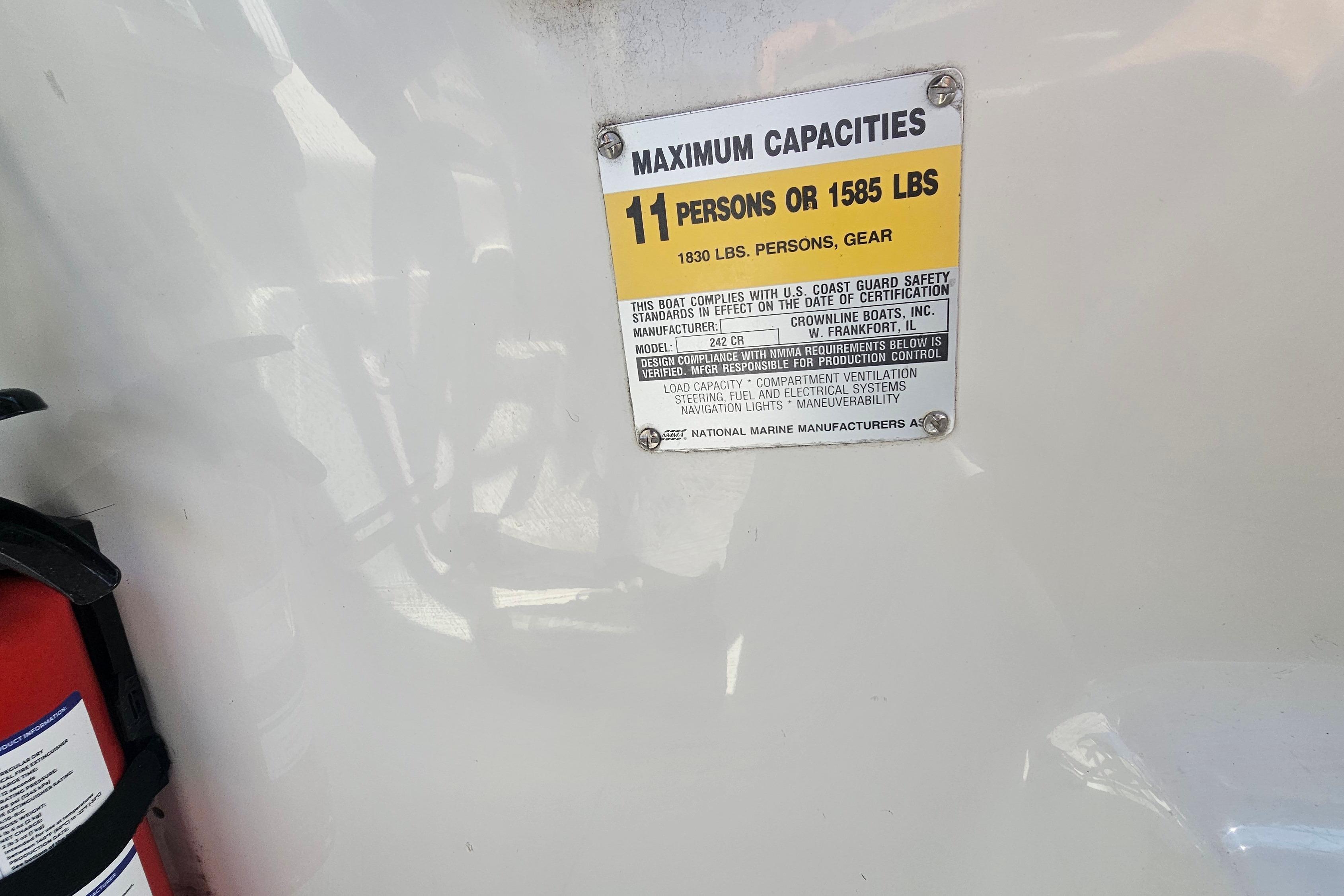 Capacity label on 2000 Crownline 242 CR boat, maximum 11 persons or 1585 lbs.