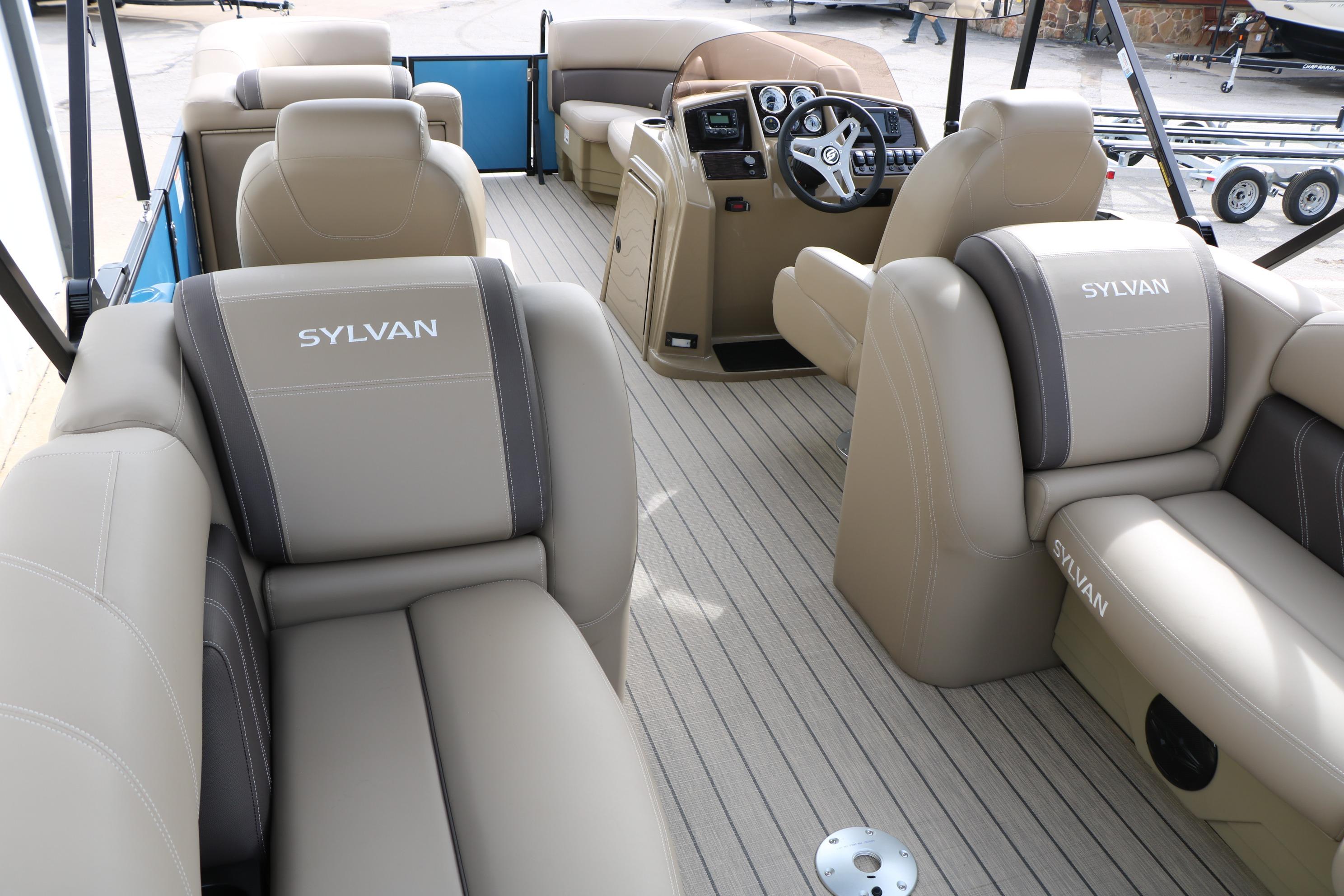 2026 Sylvan Mirage 822 LZ pontoon boat interior with beige seating and steering console.