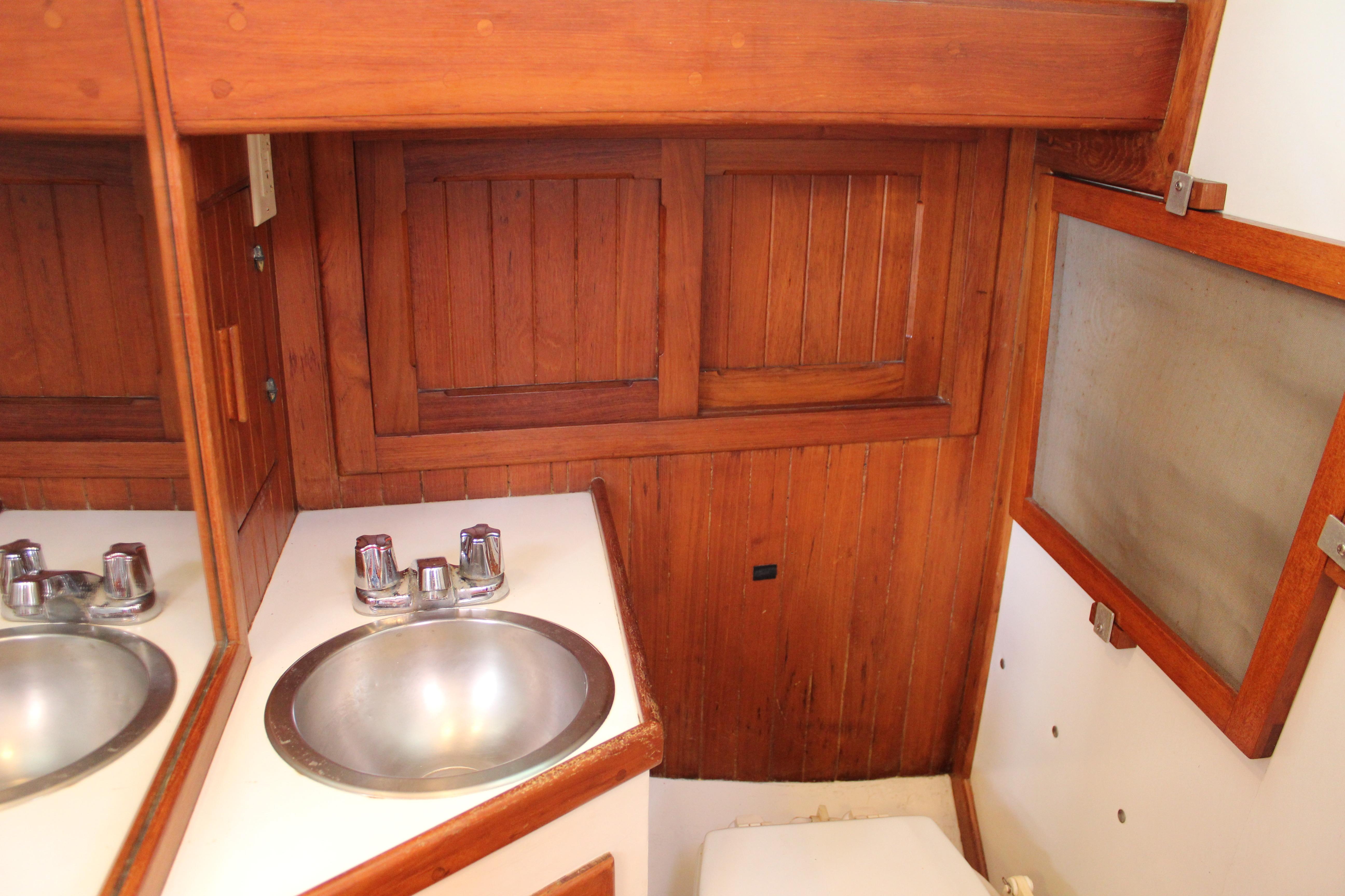 Wood-paneled bathroom with sink in 1981 Kelly Peterson 46 yacht.