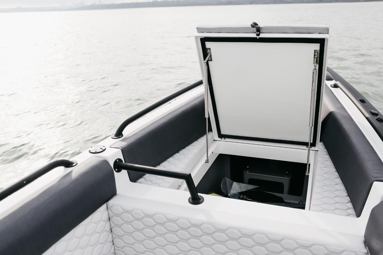 2024 Arksen Custom 10.8 boat with open storage compartment on calm water.