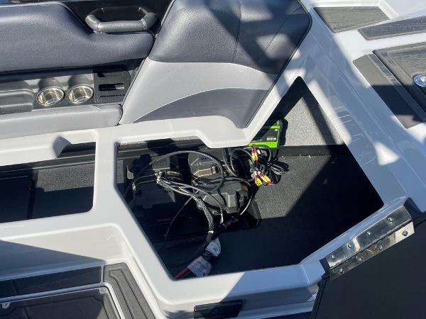 2025 Moomba Mondo boat interior storage compartment with wiring and cup holders.