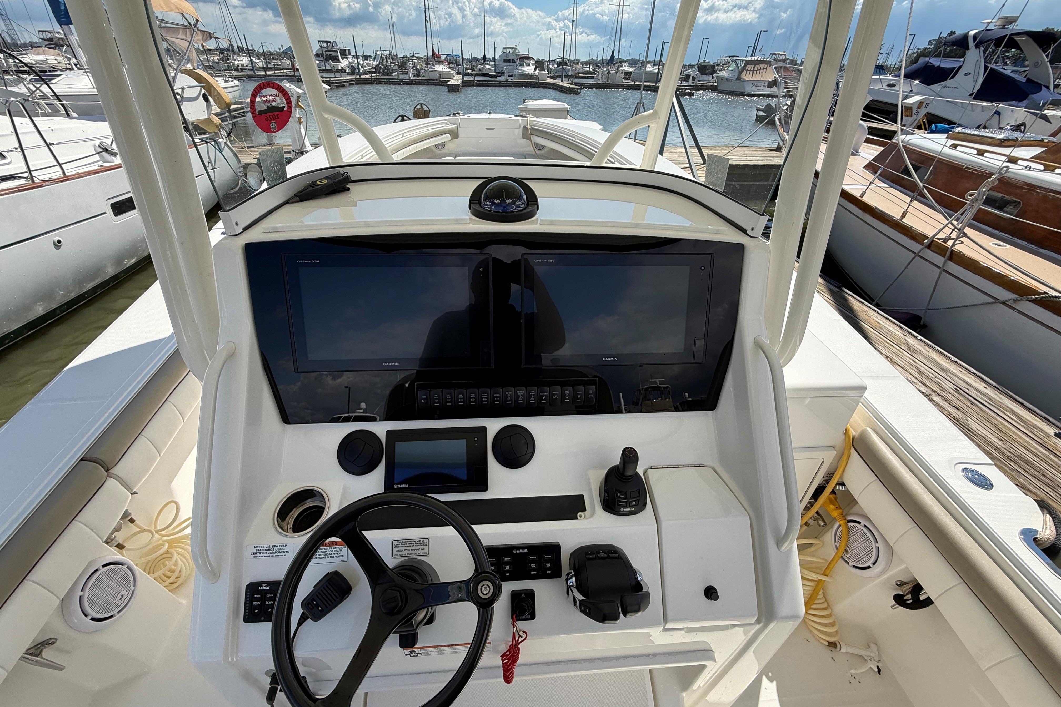 2019 Regulator 34SS boat helm with advanced navigation controls at marina.