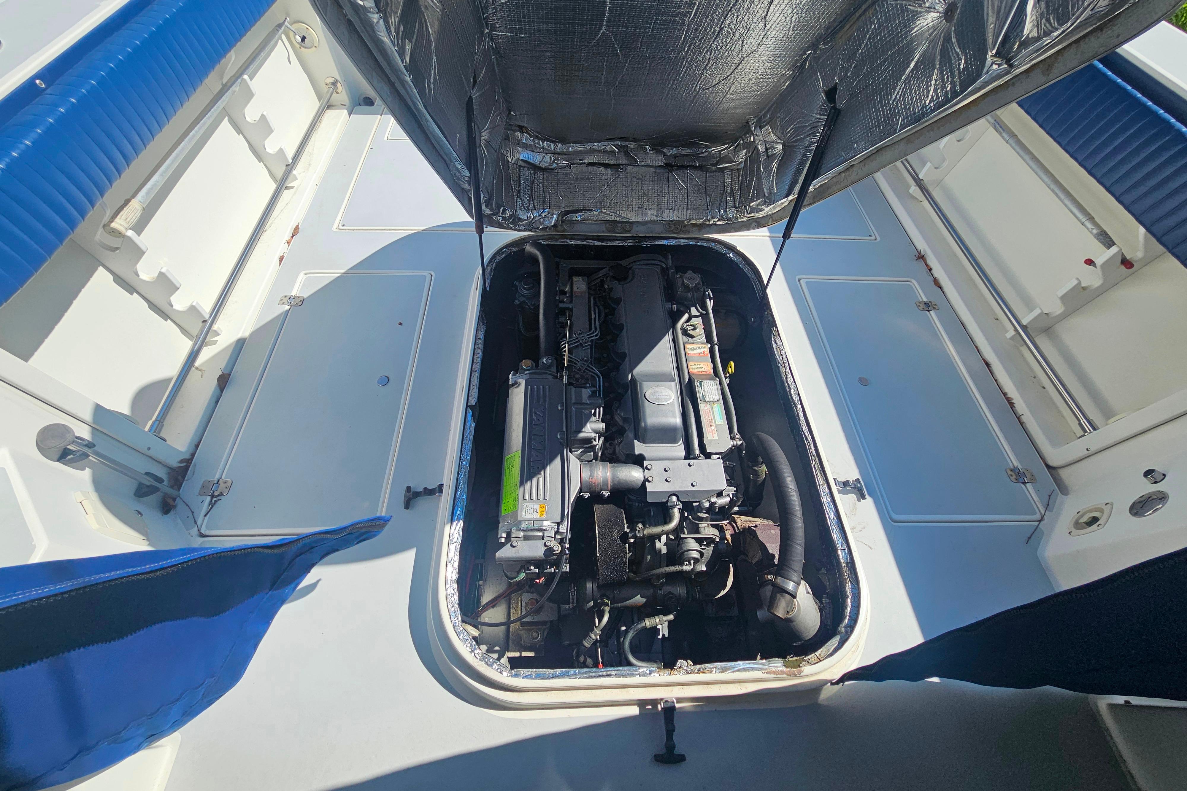 Engine compartment of a 1999 Albin 28 Tournament Express boat, showcasing detailed mechanics.
