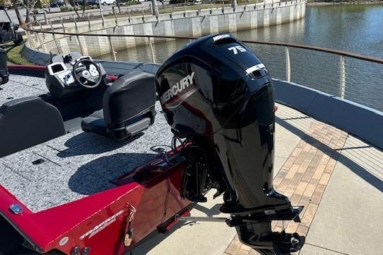 2026 Tracker Pro Team 175 boat with Mercury engine, docked by a waterfront.
