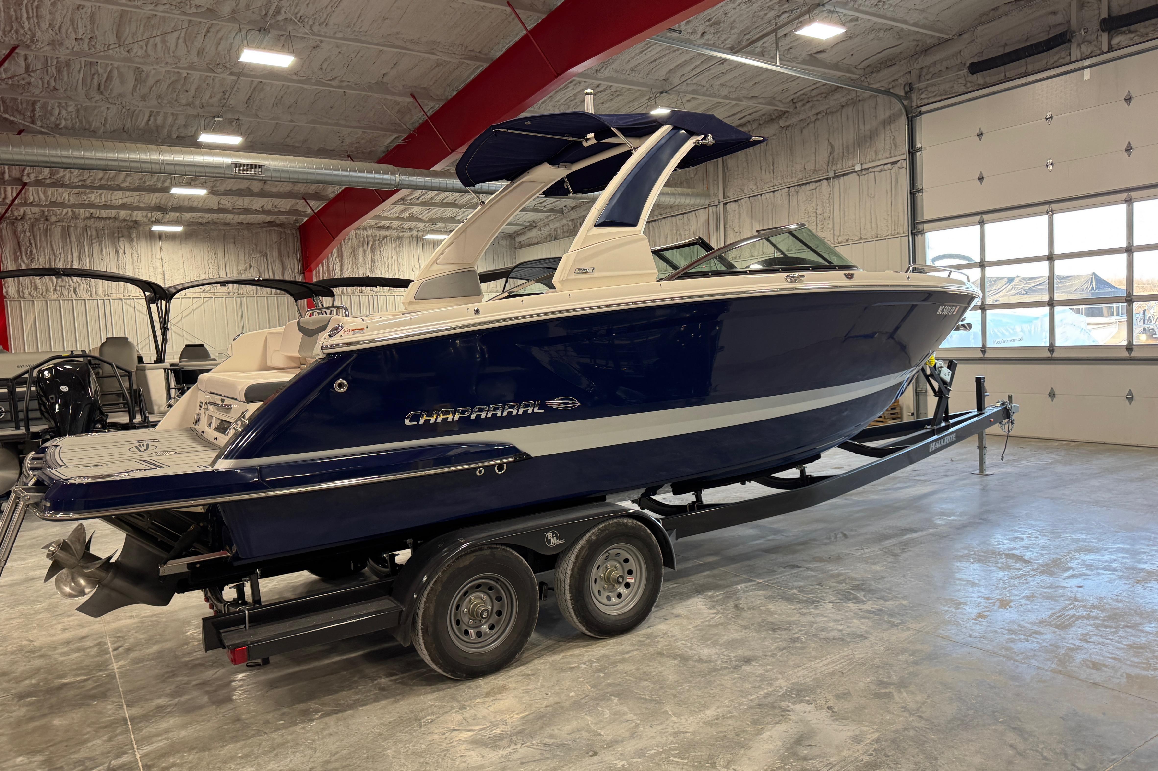 2020 Chaparral 287 SSX boat on trailer in indoor showroom.