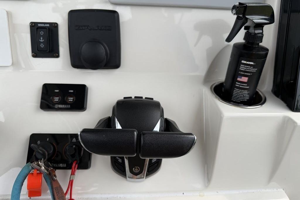 Control panel of 2023 Stingray 273 CC boat with Yamaha controls and cleaning spray bottle.