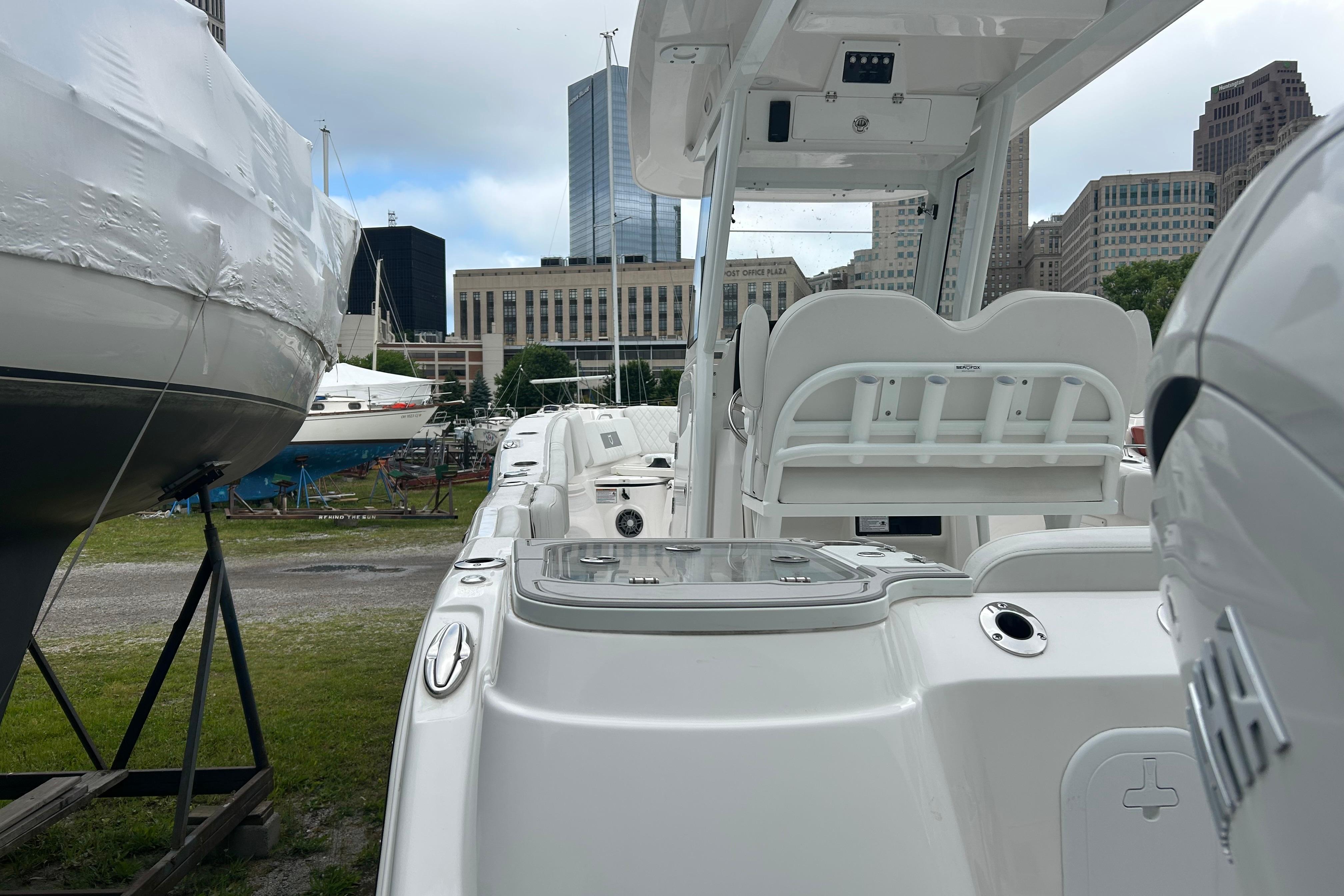 2026 Sea Fox 268 Commander boat docked in urban marina setting.