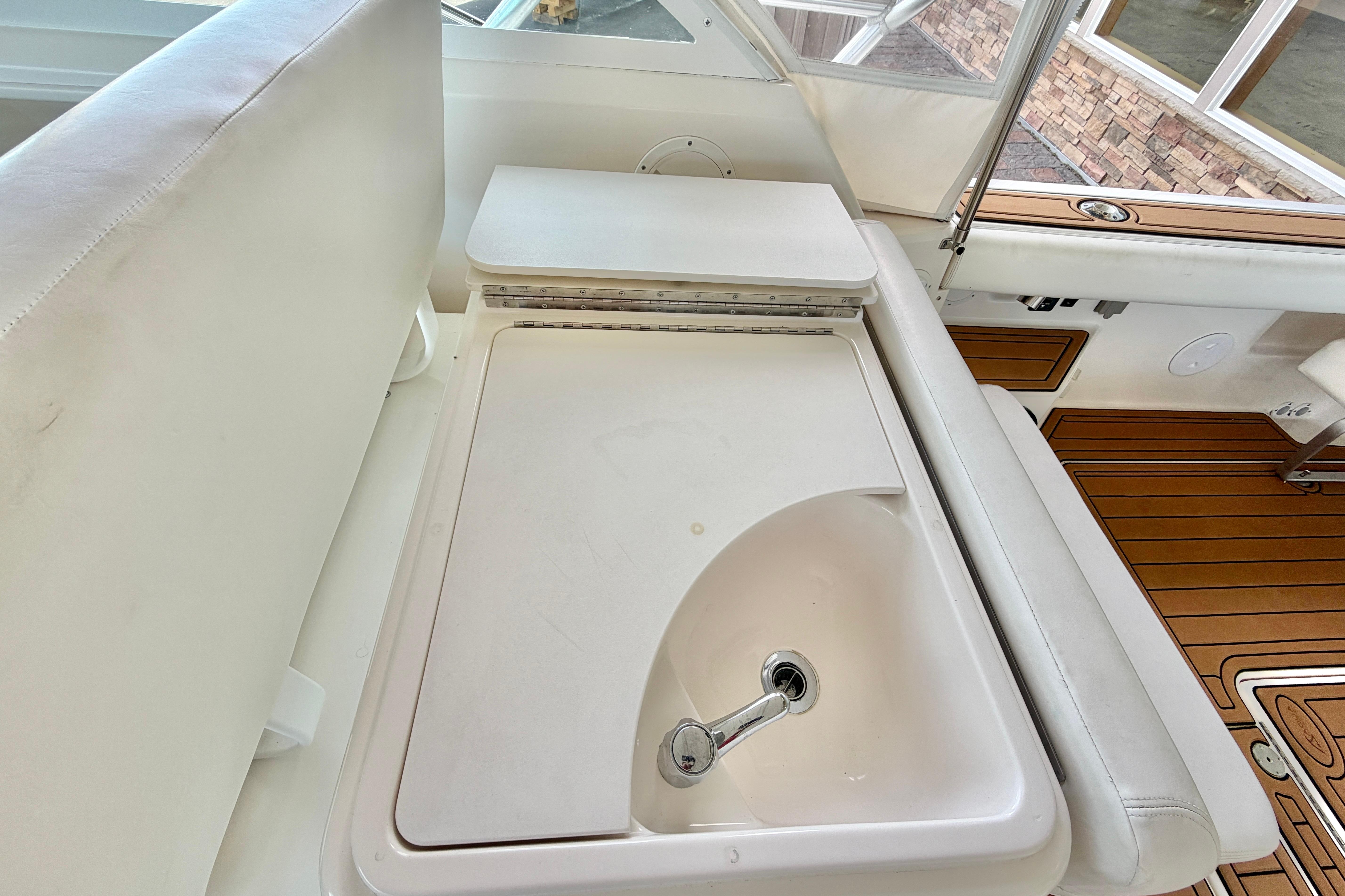 1999 Tiara Yachts 2900 Coronet interior with sink and seating area.