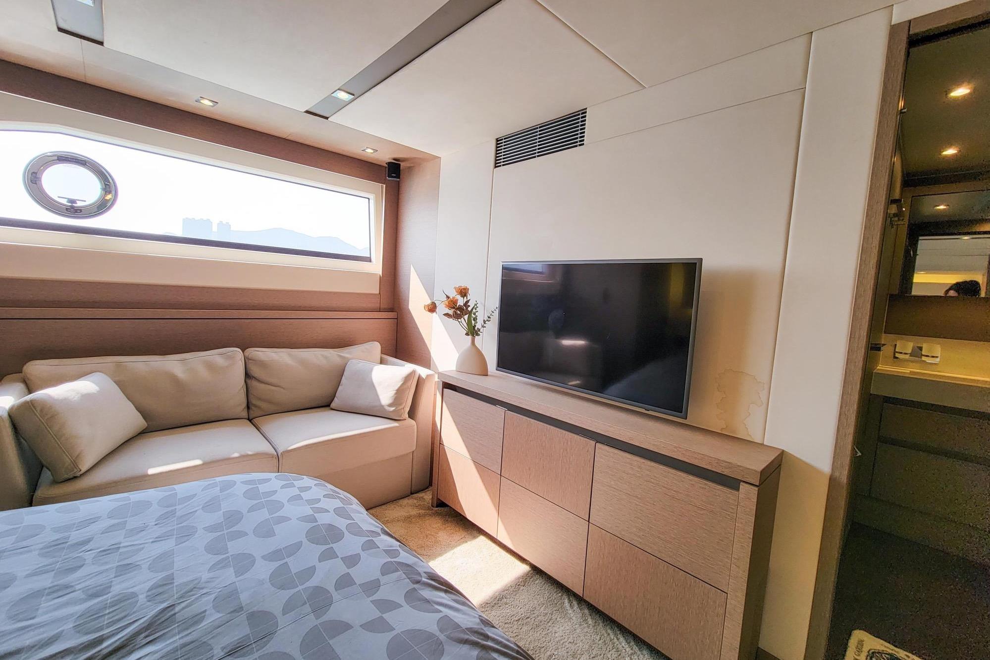 Luxurious interior of 2019 Prestiage 630 yacht with sofa, TV, and modern decor.