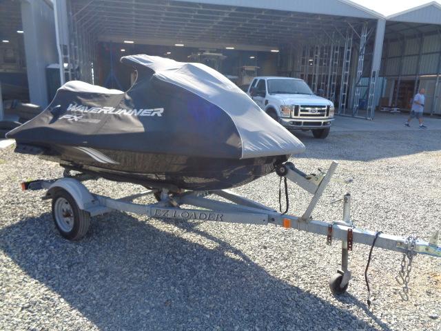 2015 Yamaha WaveRunner FX Cruiser H/O on trailer, covered, parked outside a garage.
