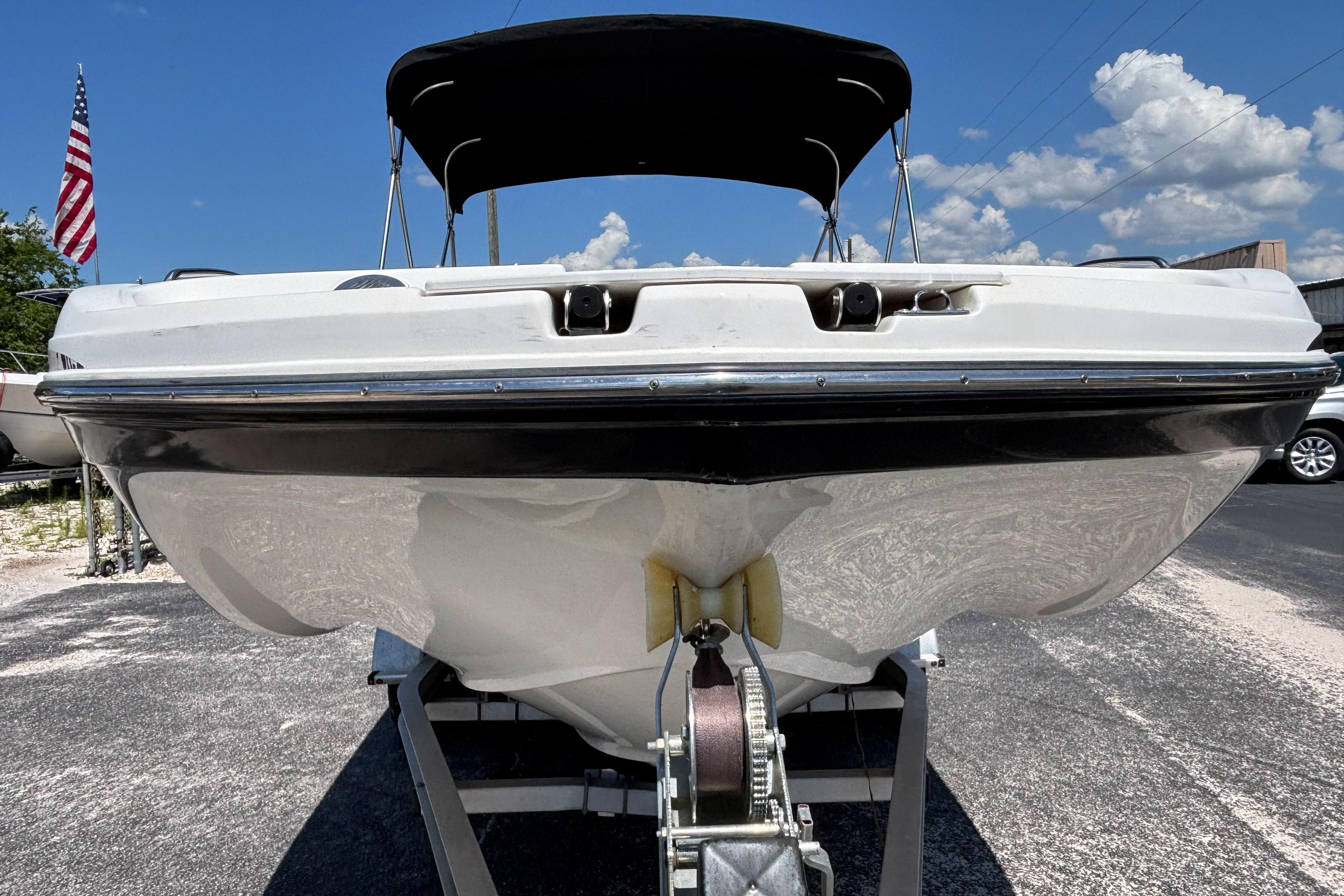 2019 Hurricane Sundeck Sport 218 OB boat on trailer, under clear blue sky.