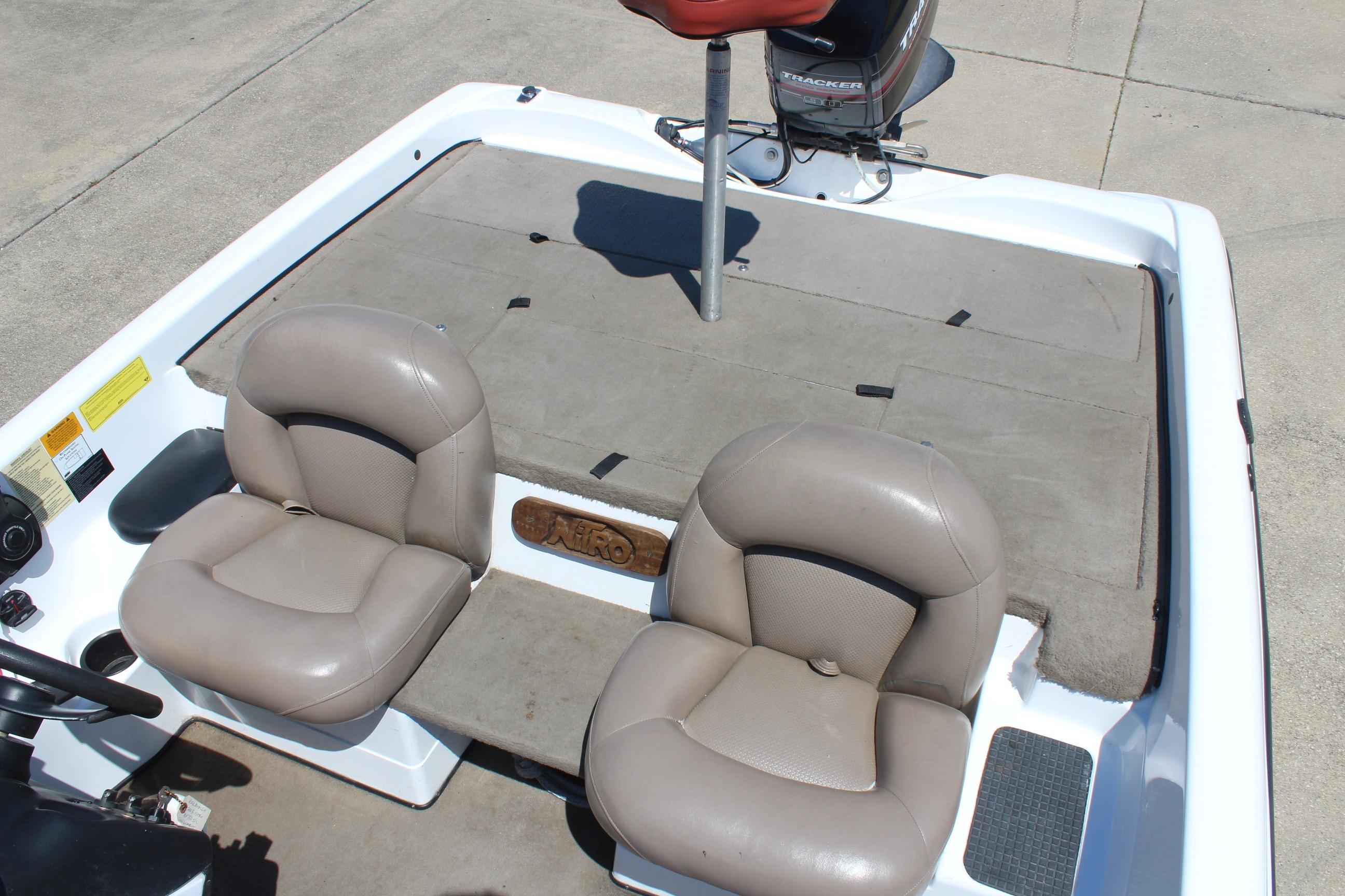 2003 Nitro NX 750 SC boat interior with two beige seats and a motor.