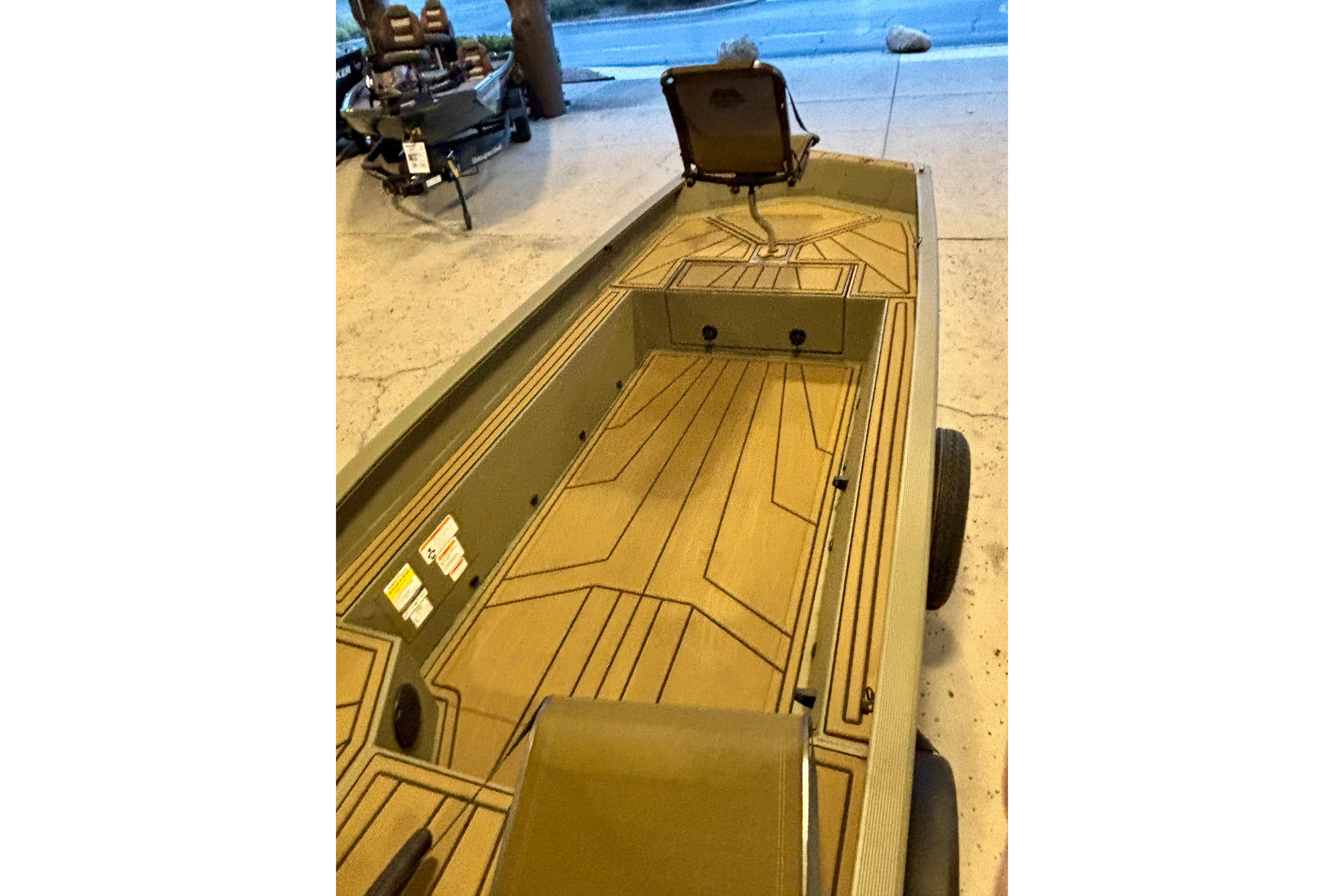 2026 Tracker Grizzly 1650 T Prairie Wings Edition boat interior with seating and storage.