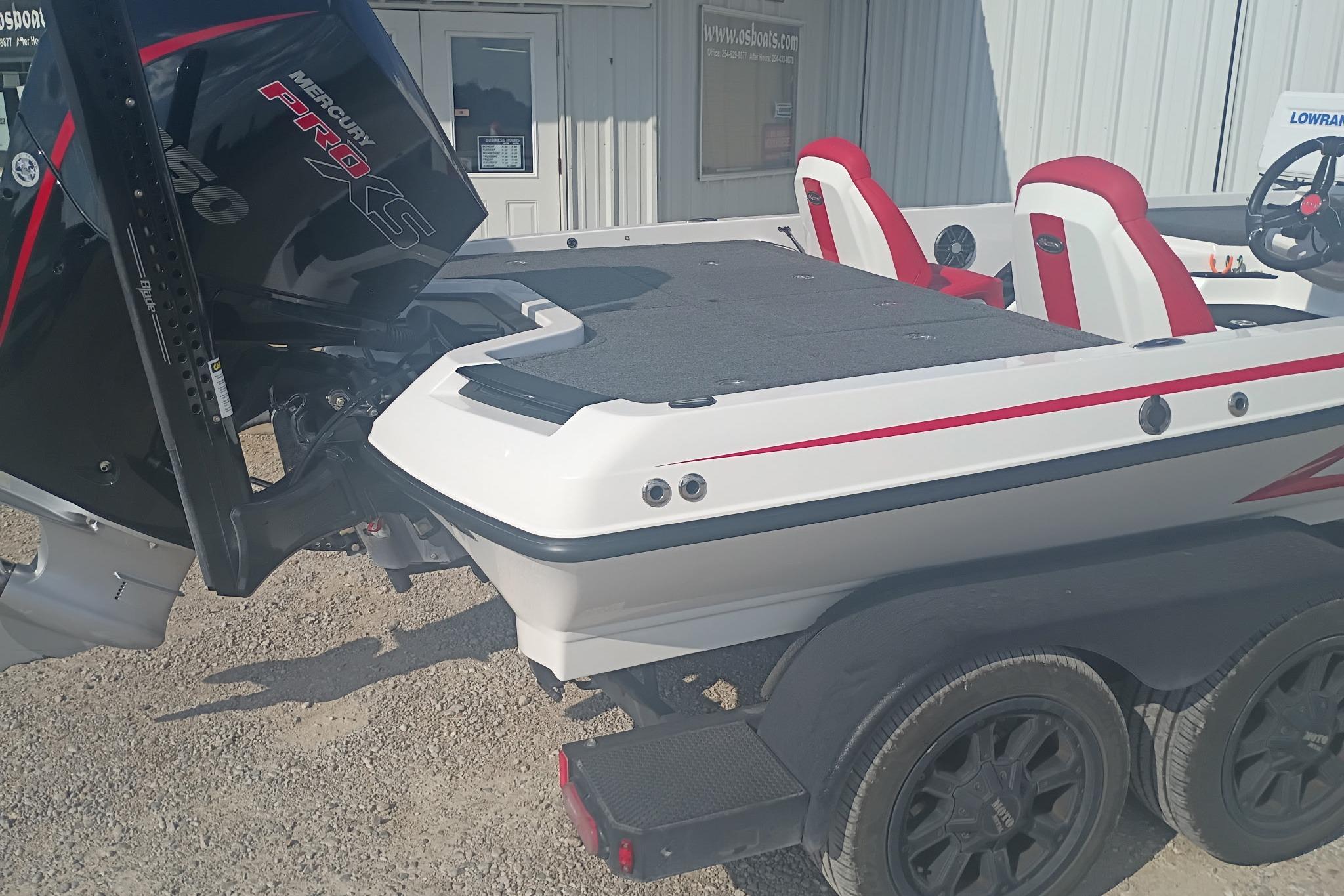 2024 iKon LX21 boat with Mercury Pro XS engine, red and white seats, on a trailer.