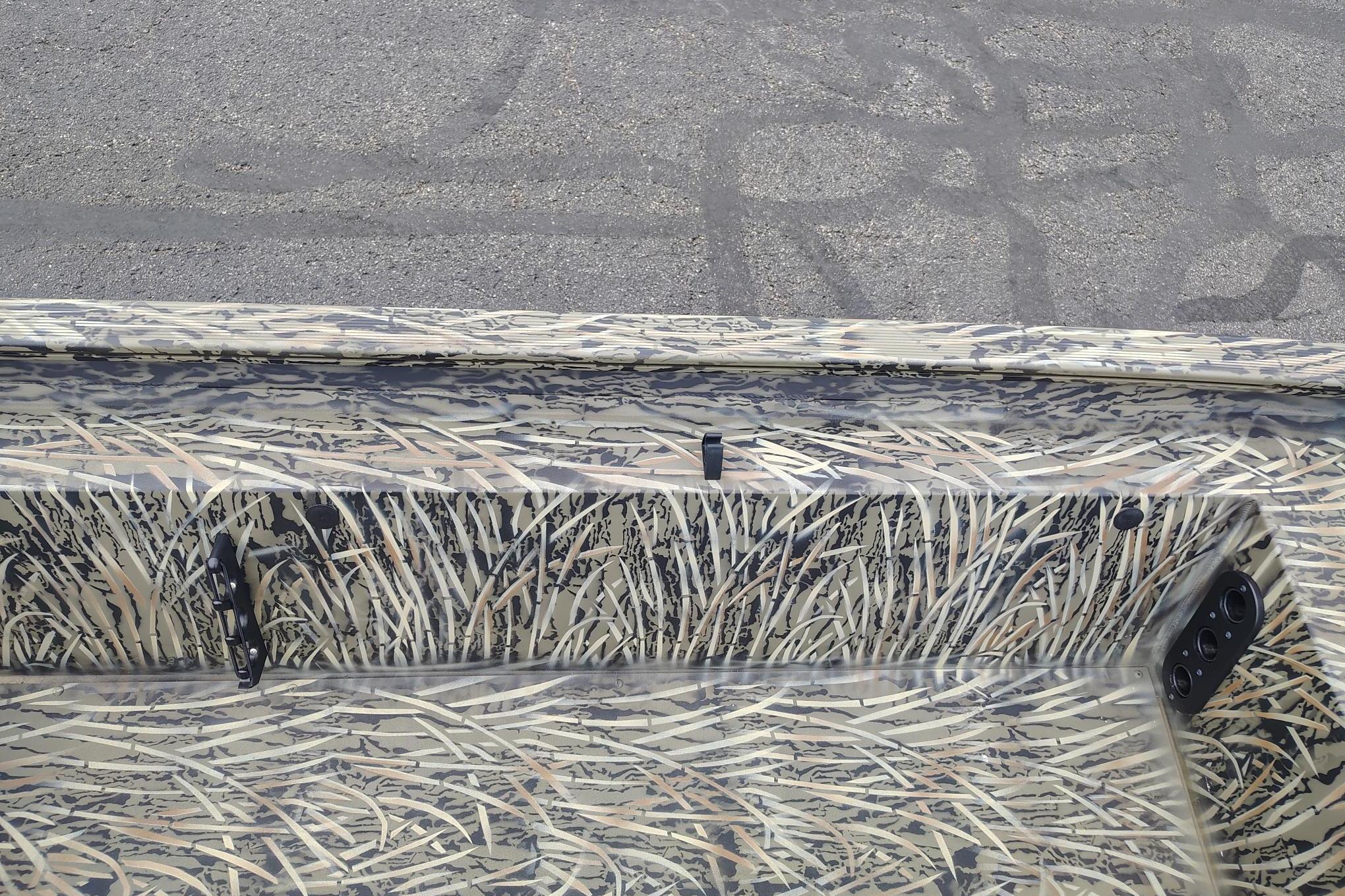 2026 Tracker Grizzly 1754 SC boat with camouflage pattern on a paved surface.