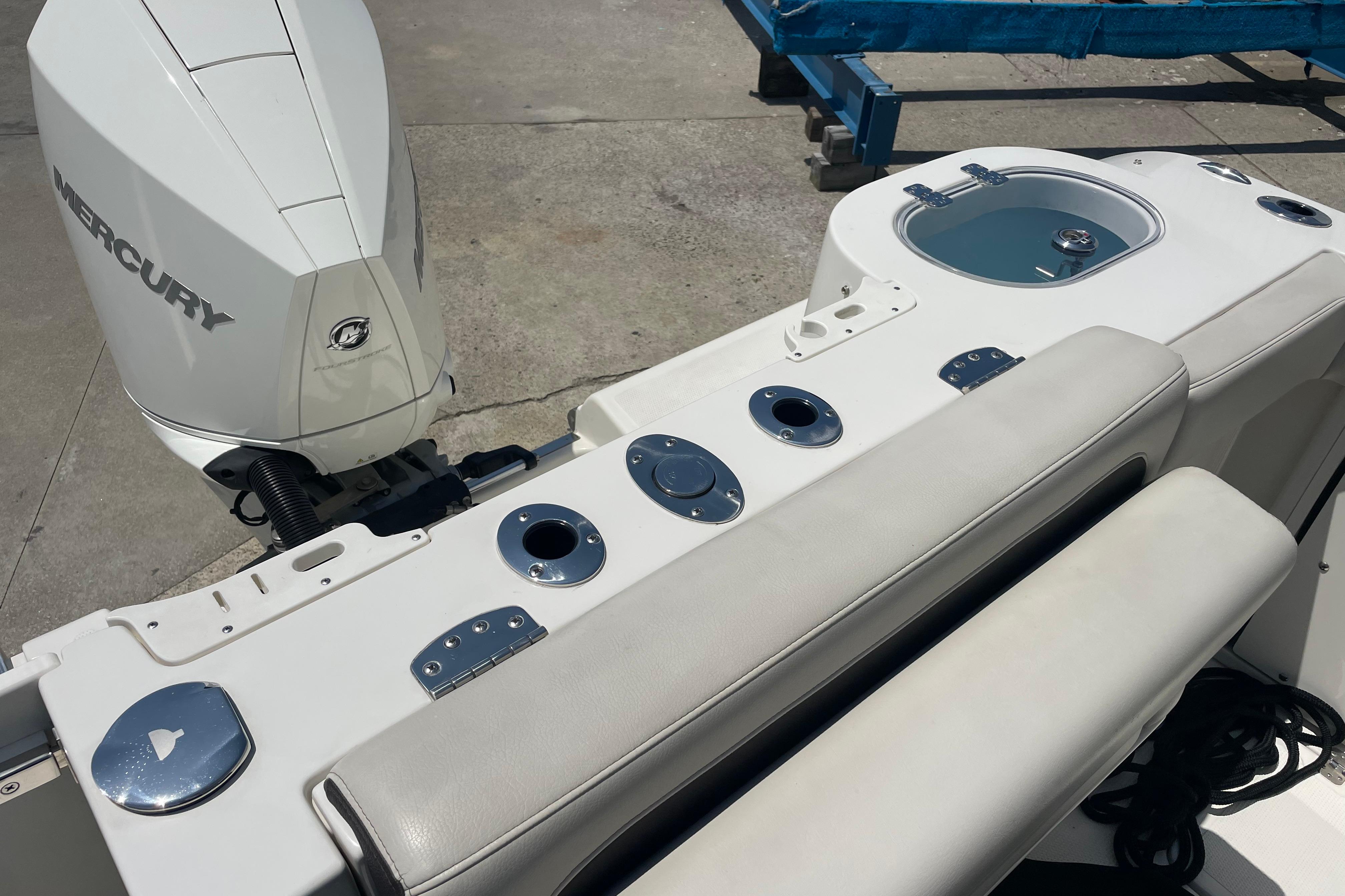 2022 Sailfish 245 DC boat with Mercury engine, featuring seating and fishing rod holders.