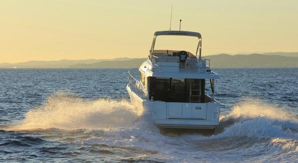 2021 Beneteau Swift Trawler 35 cruising at sunset.