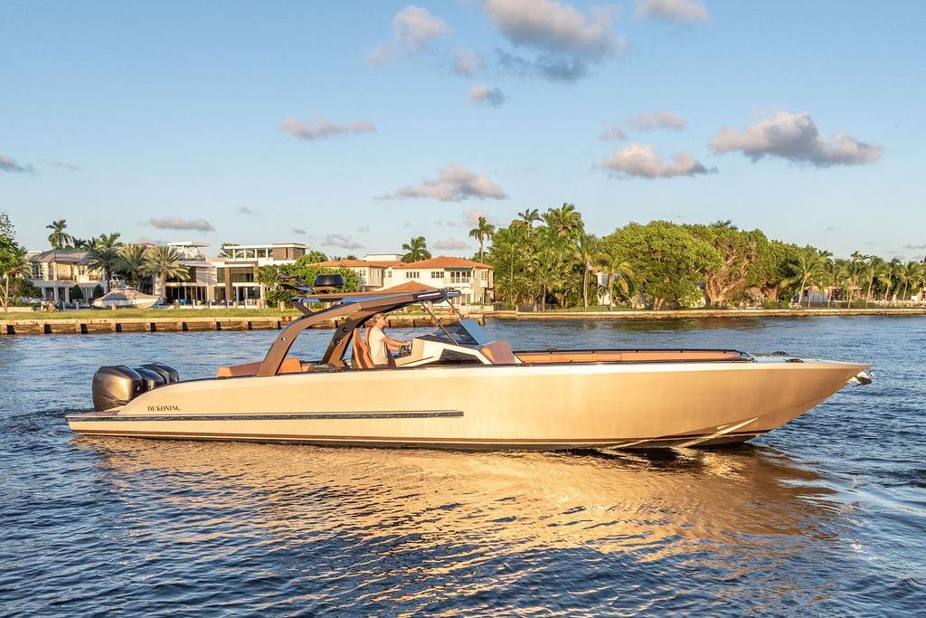 Luxury DeKoning 43 boat cruising on a sunny day, 2023 model.