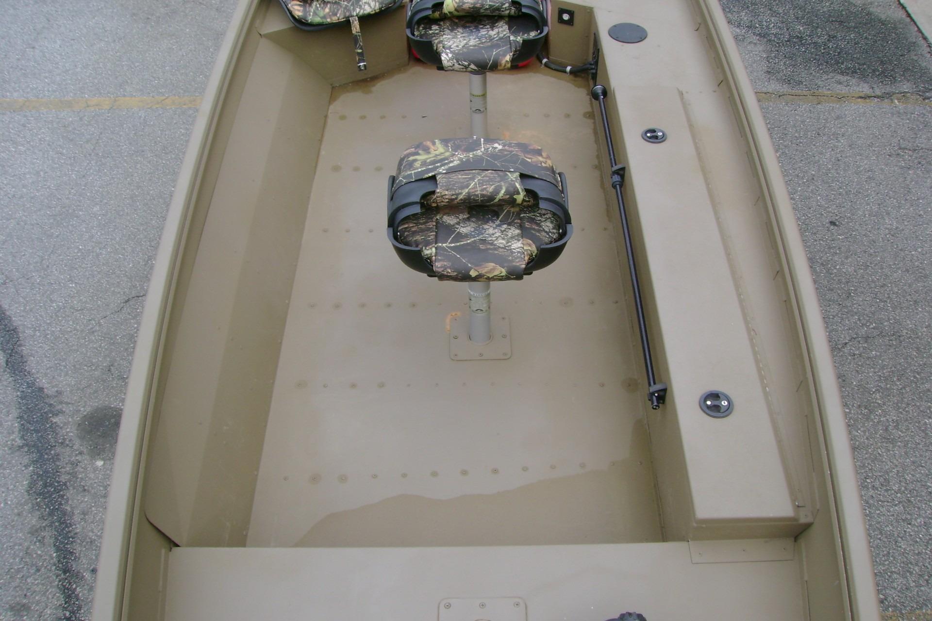 2023 G3 1652 DK boat interior with camouflage seats and spacious layout.