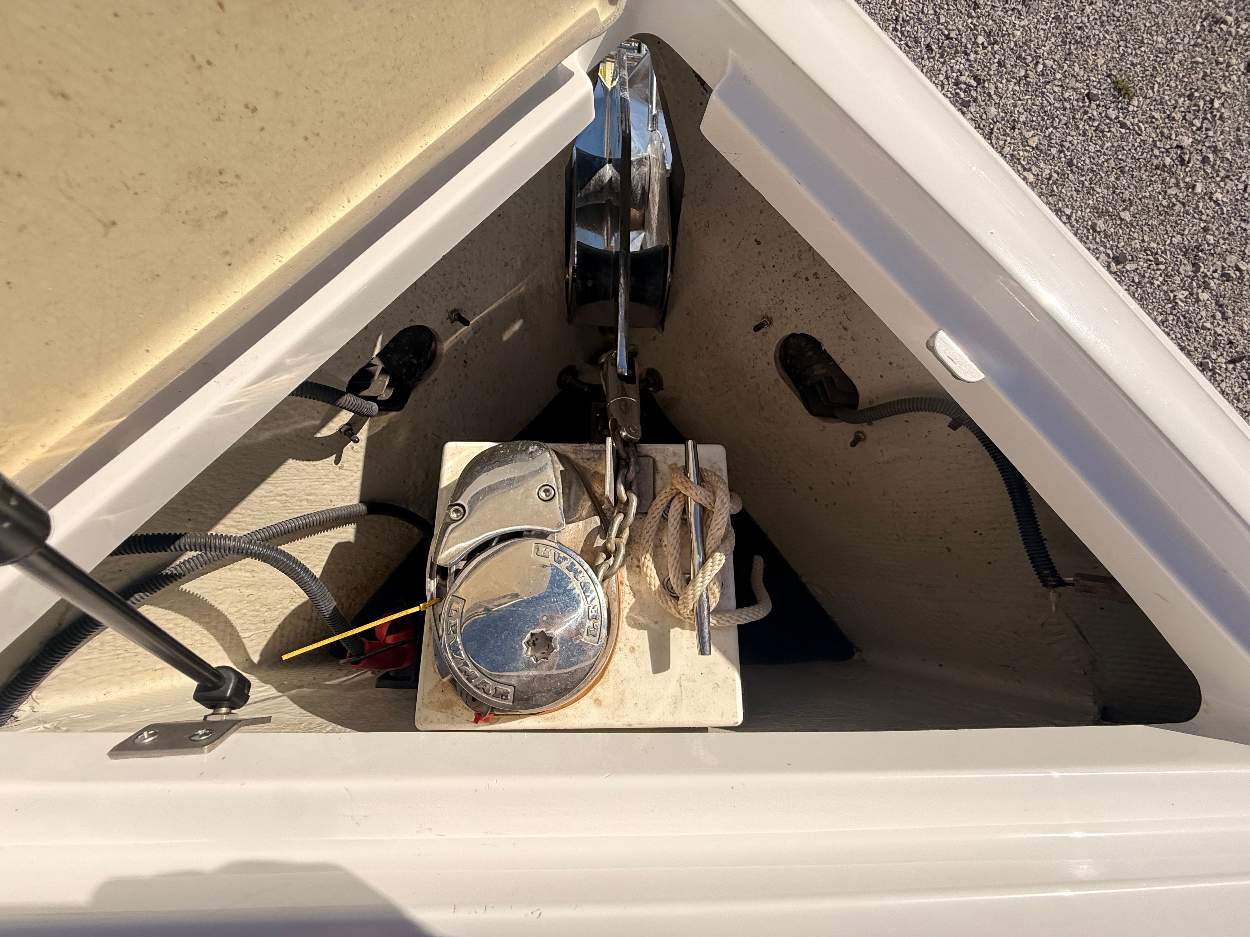 The anchor locker of a 2019 Cobalt R7 Surf with a windlass and rope is visible.