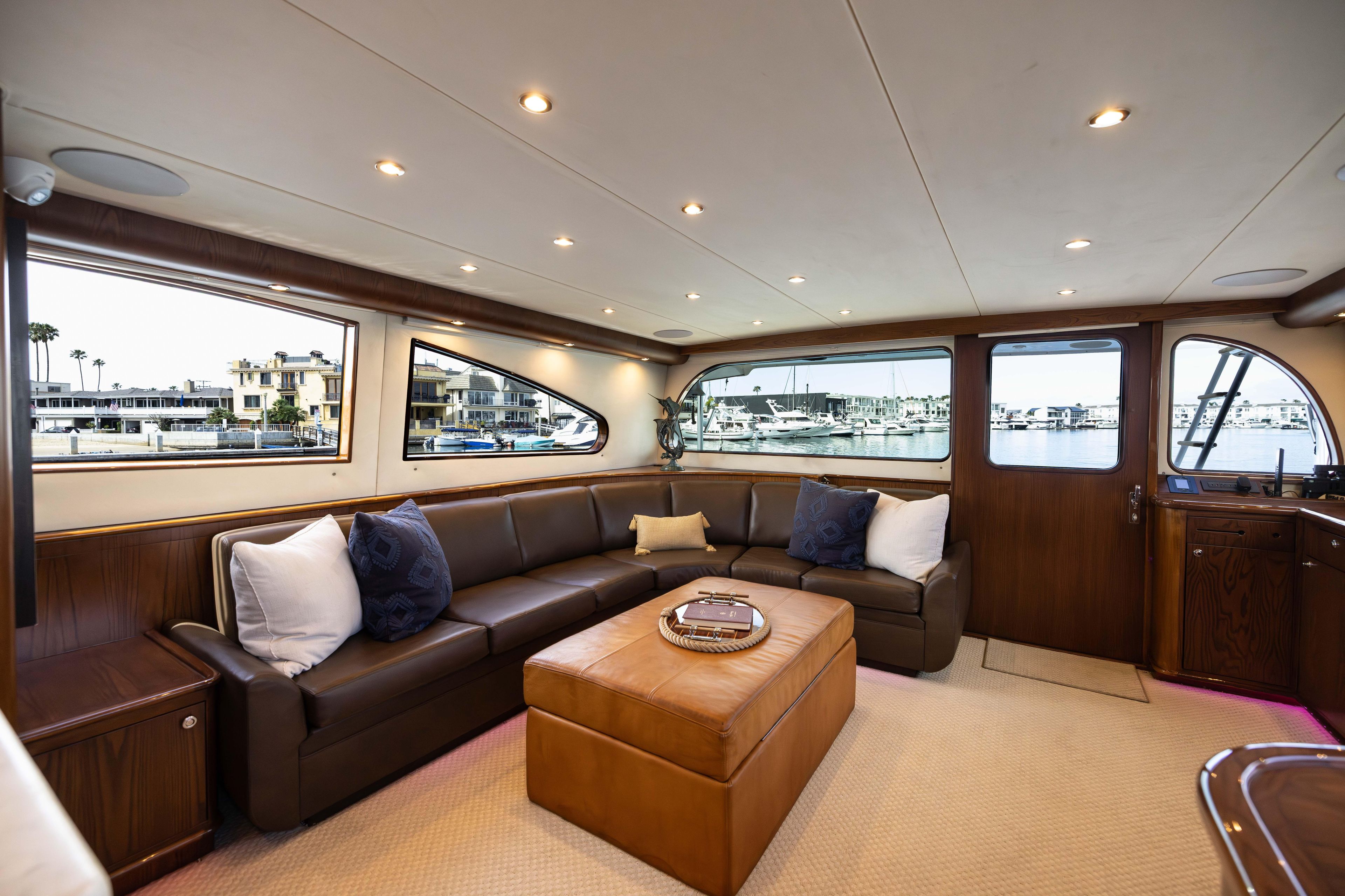 Luxurious interior of a 1993 Lydia Sportfisher yacht with leather seating and marina view.