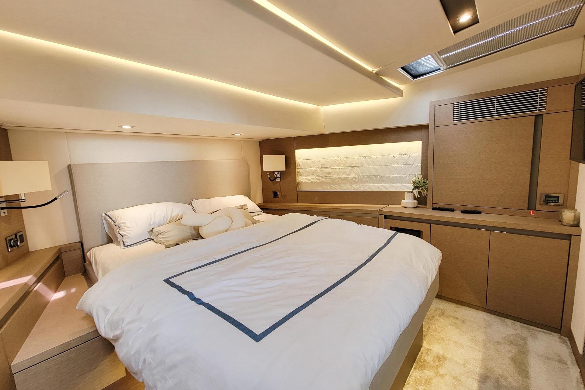 Luxurious bedroom interior of 2019 Prestiage 630 yacht with modern design and ambient lighting.