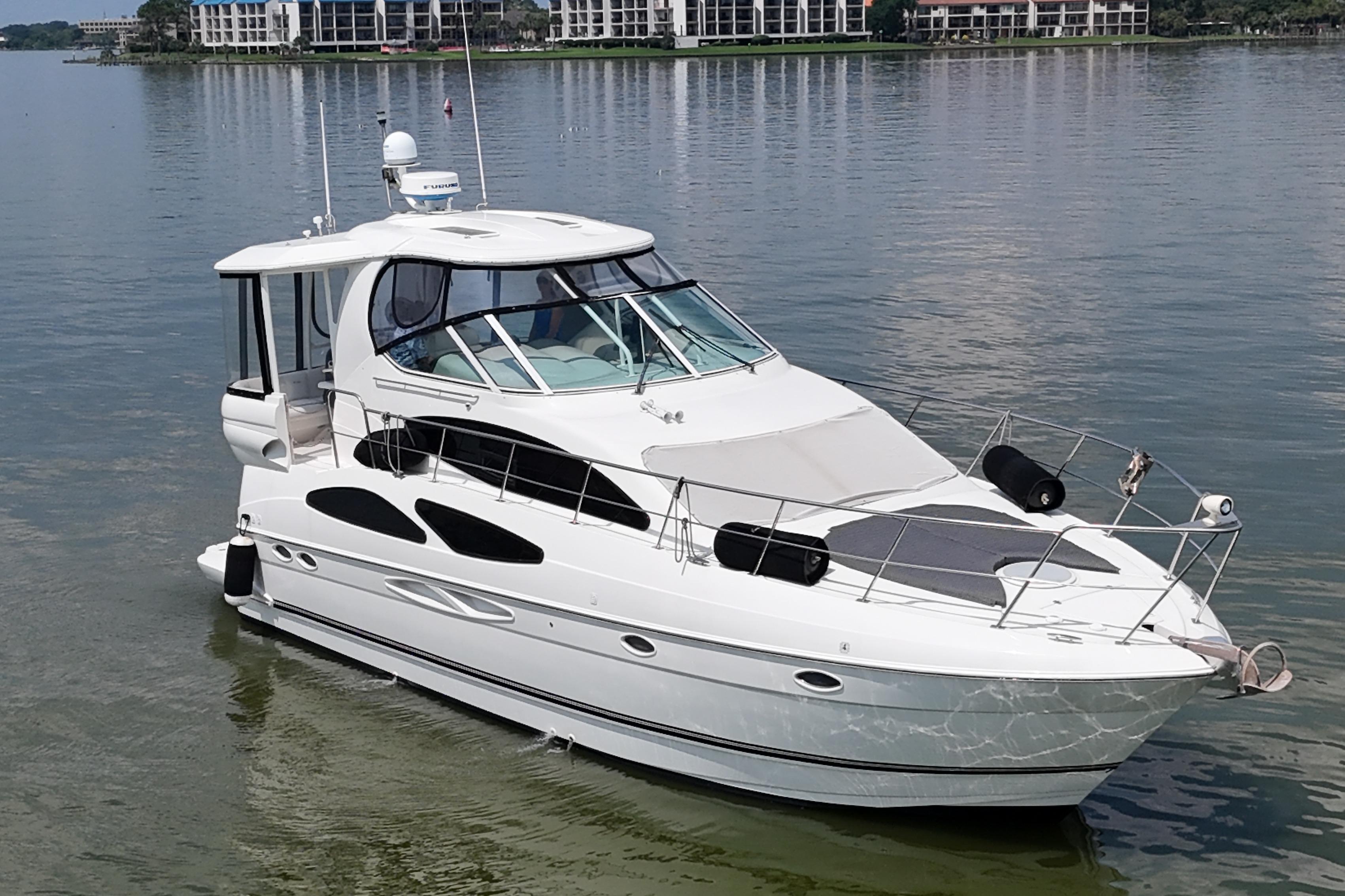 2004 Cruisers Yachts 405 Express Motoryacht on calm water, showcasing sleek design.