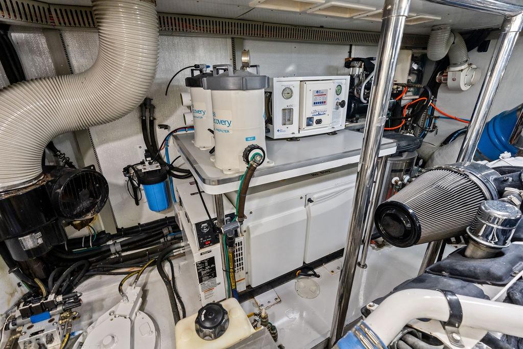 Engine room of a 2005 Horizon 82 yacht with filtration systems and machinery.