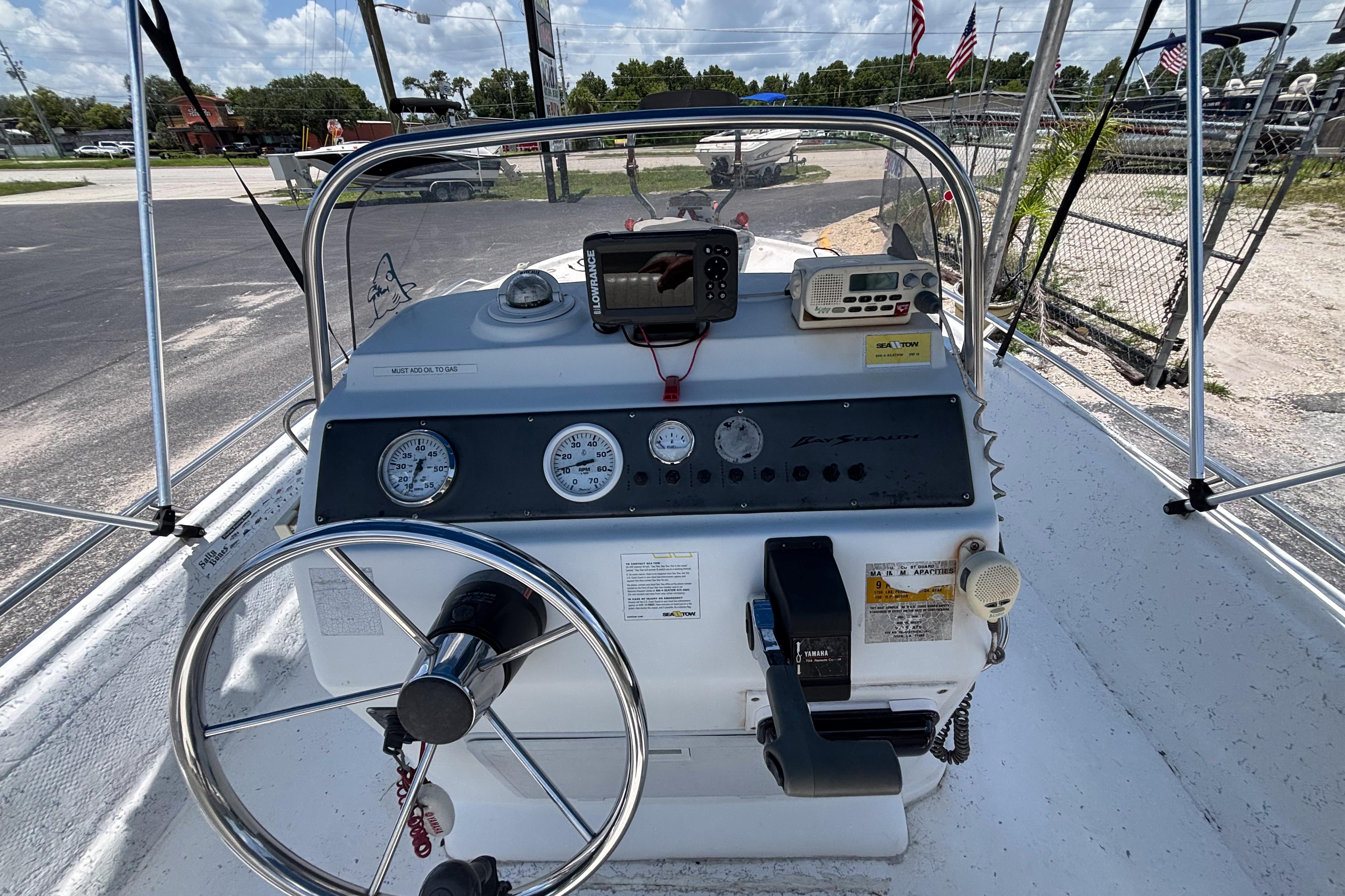 Console of a 2000 VIP 1880 BAY STEALTH boat with steering wheel and gauges.