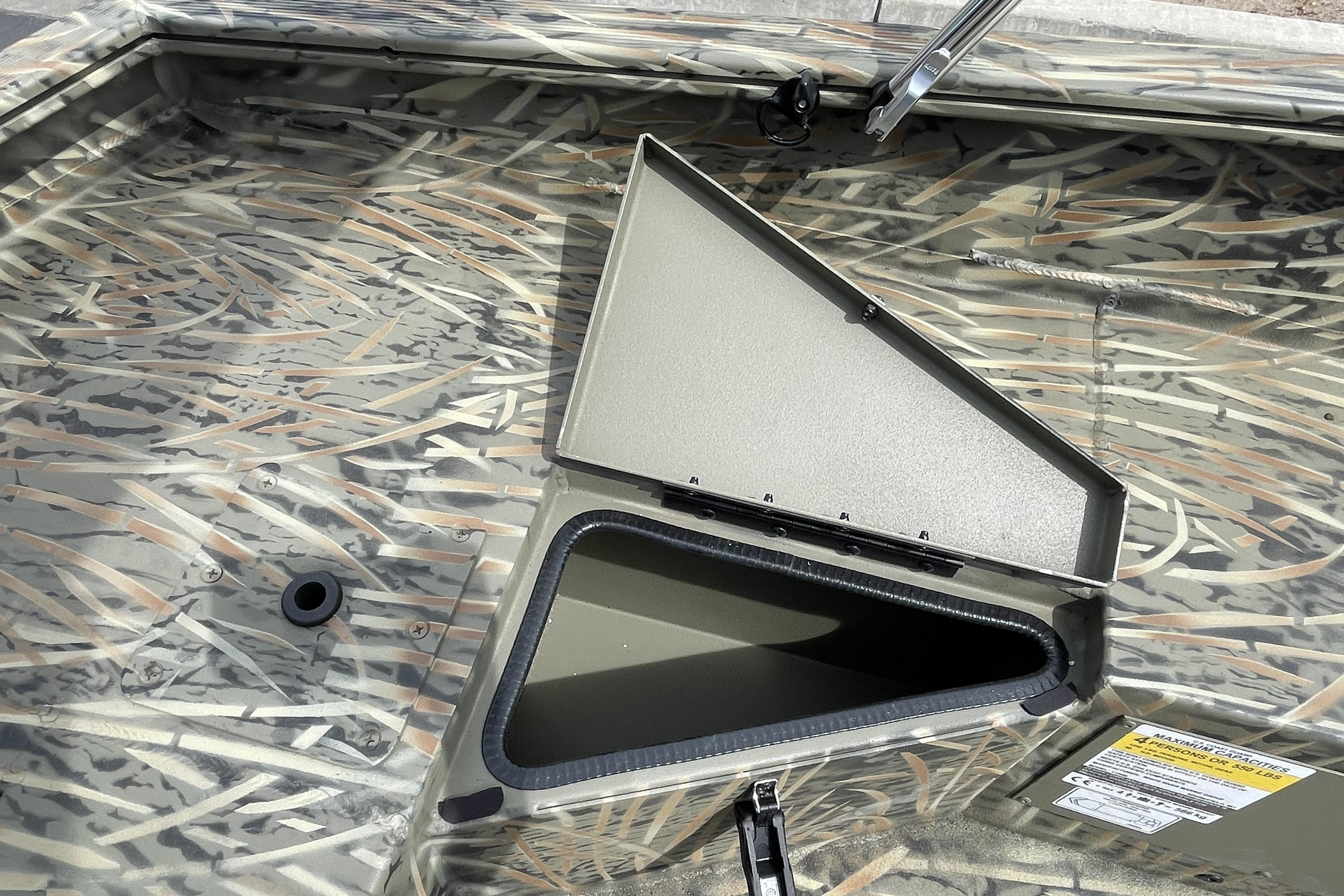 2026 Tracker Grizzly 1756 T Marsh boat interior with open storage compartment.