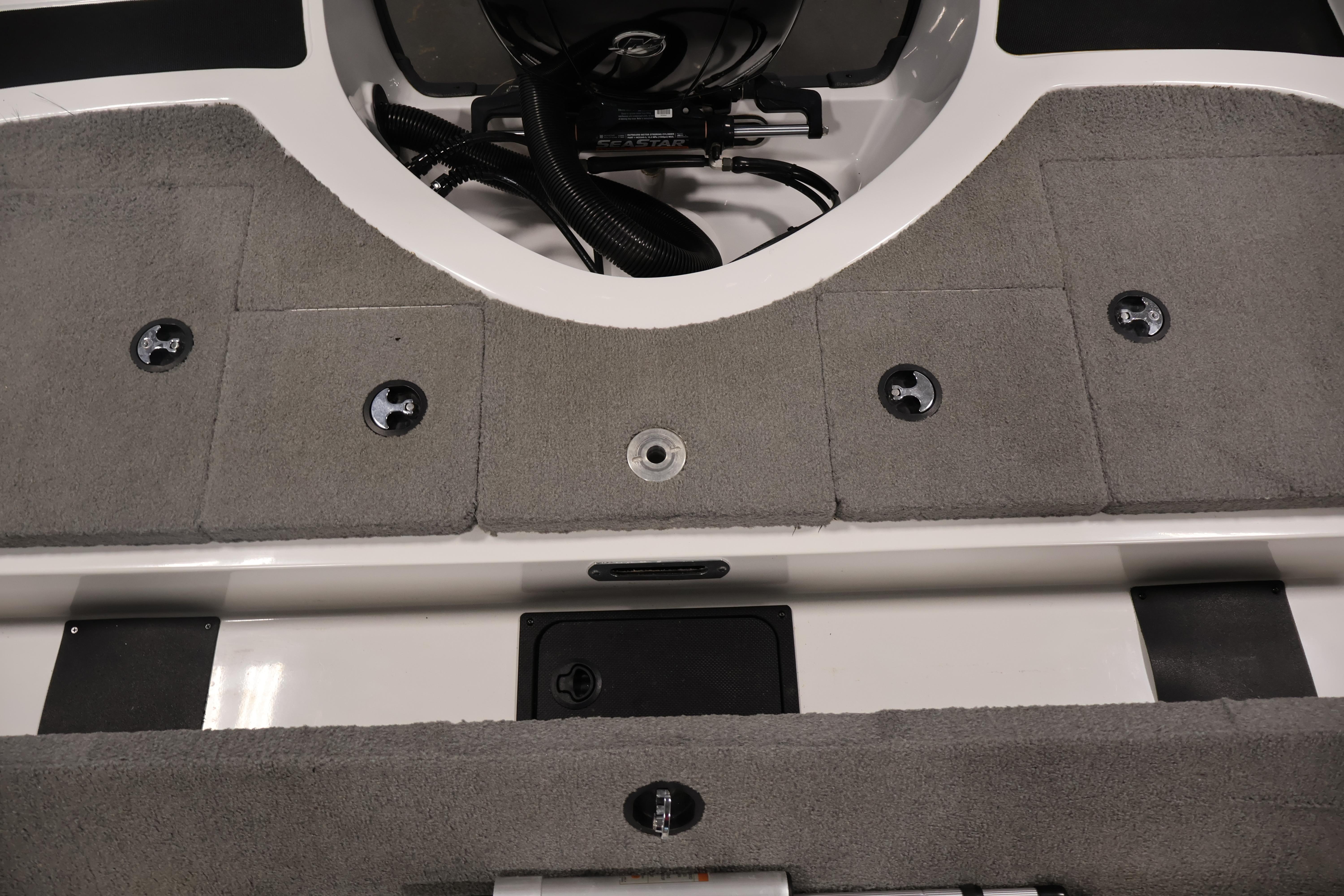 2019 Nitro Z19 Sport boat interior with gray carpet and storage compartments.