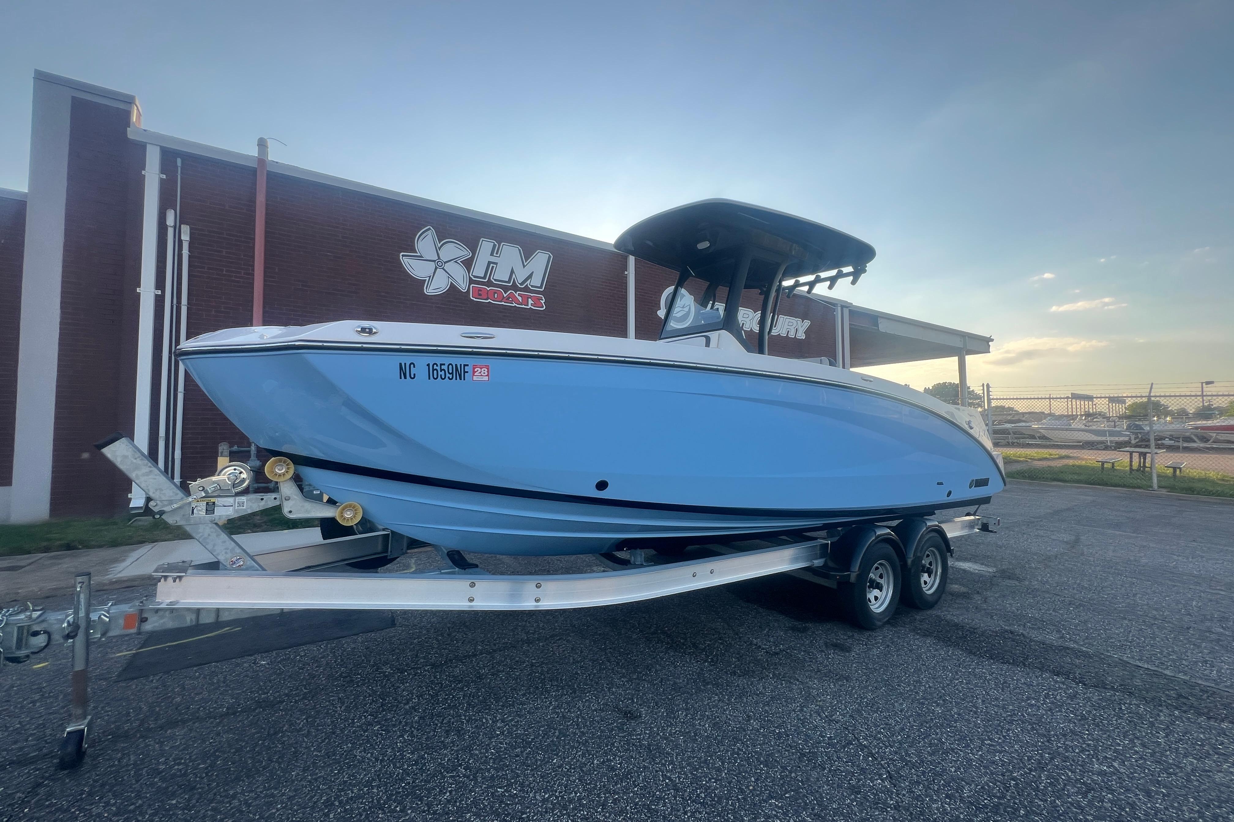 2024 Yamaha Boats 255 FSH Sport H on trailer outside HM Boats dealership.