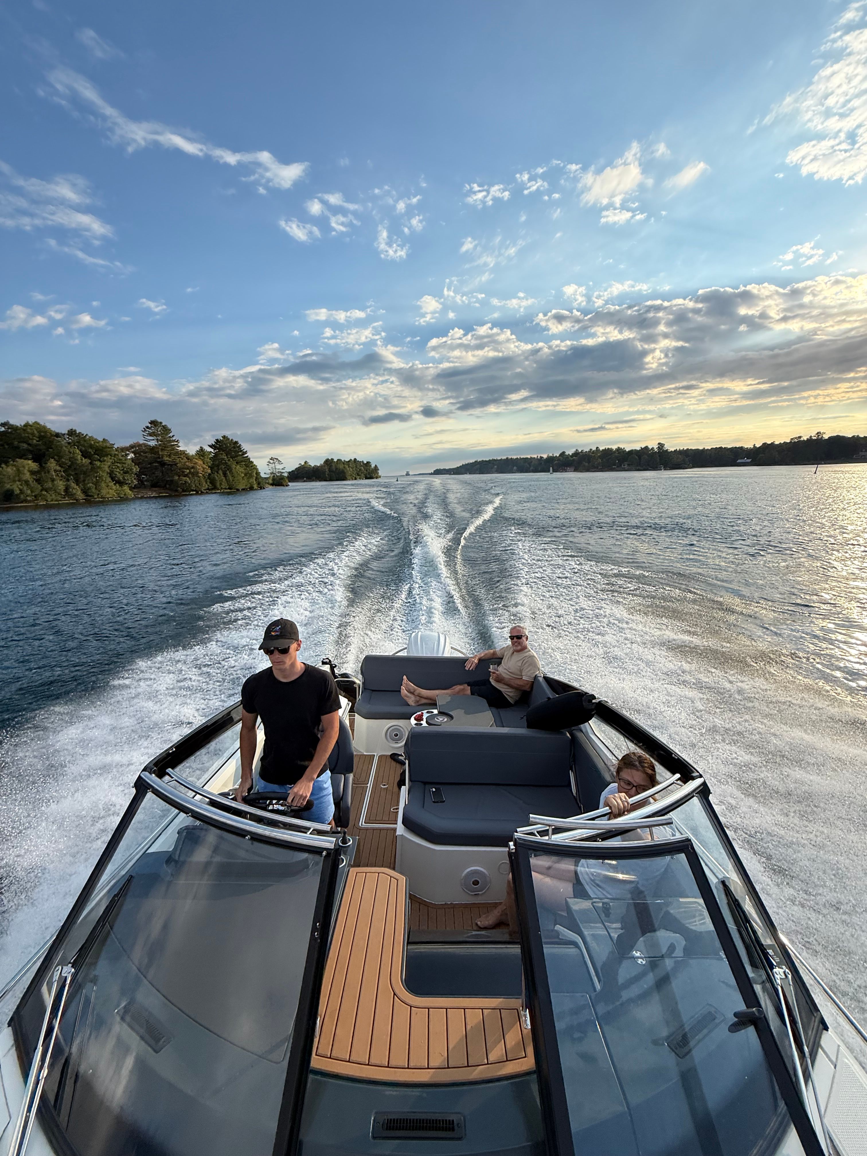 2022 Parker Poland 800 Cruiser on calm water with three people on board.