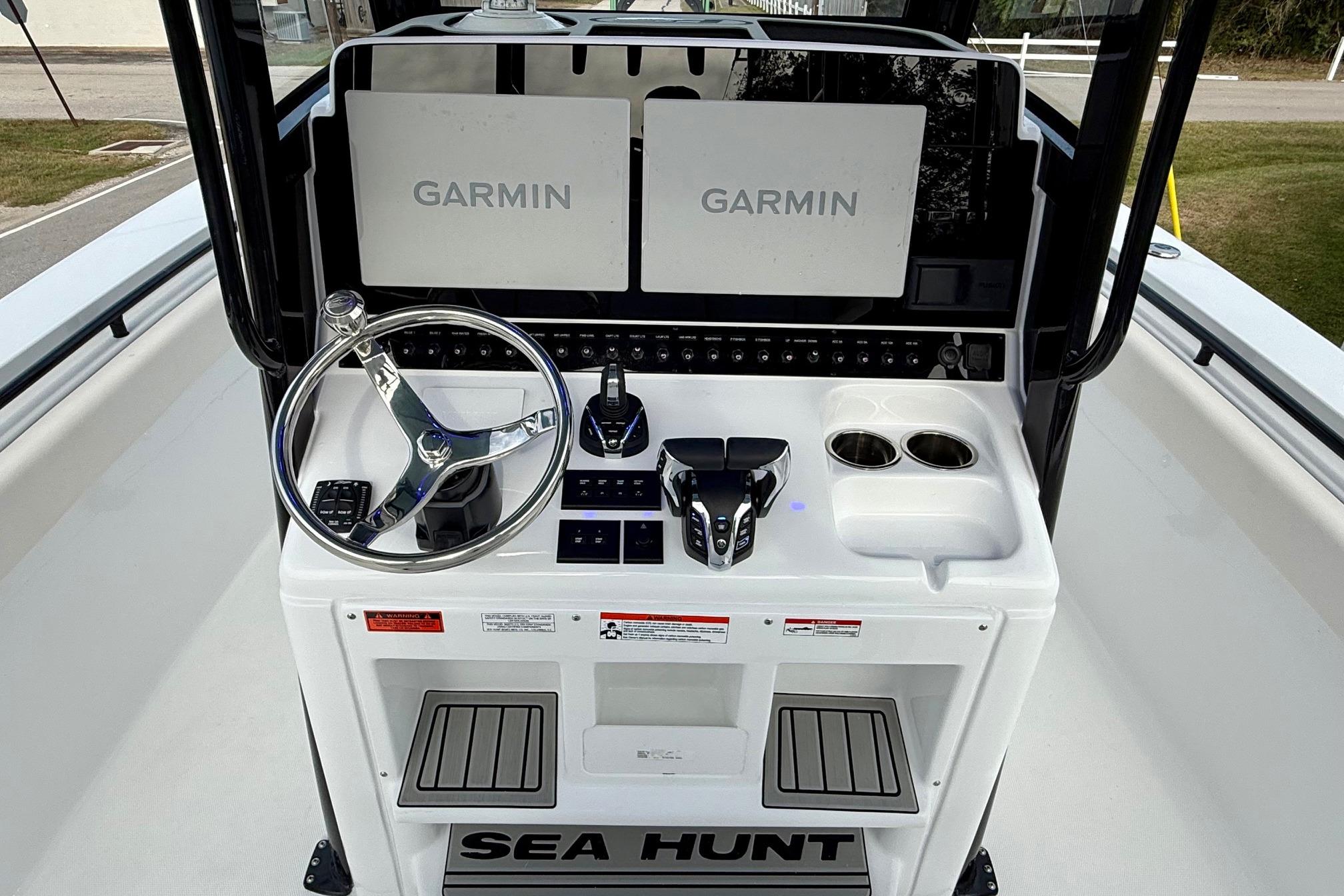 2026 Sea Hunt Gamefish 30 Coffin Box boat dashboard with Garmin displays and steering wheel.