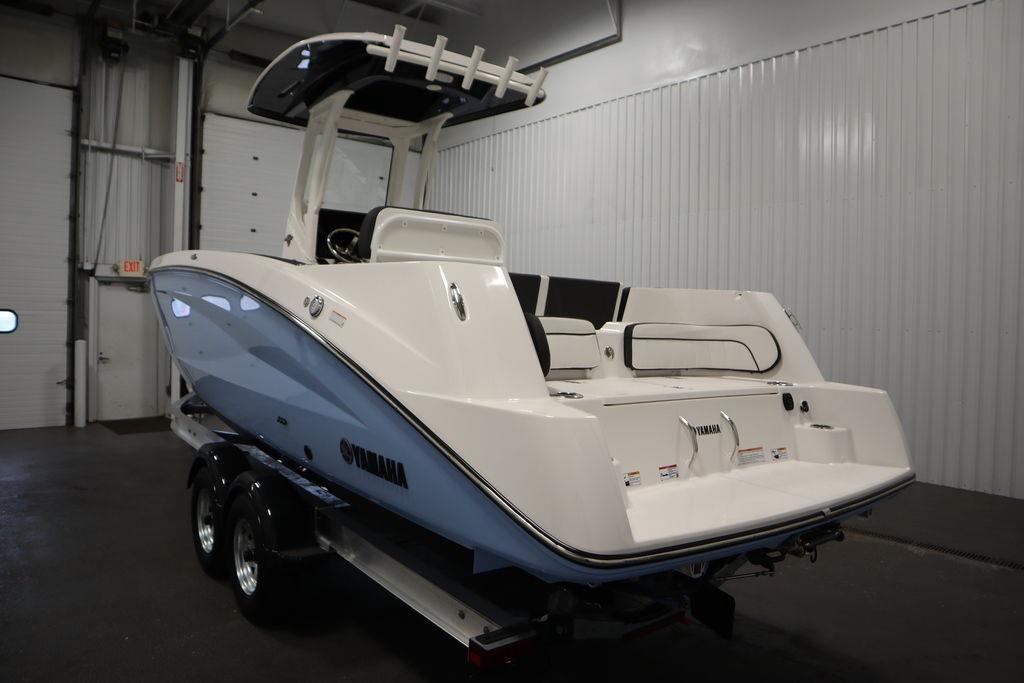 2026 Yamaha Boats 255 FSH Sport E in a showroom, rear view on trailer.