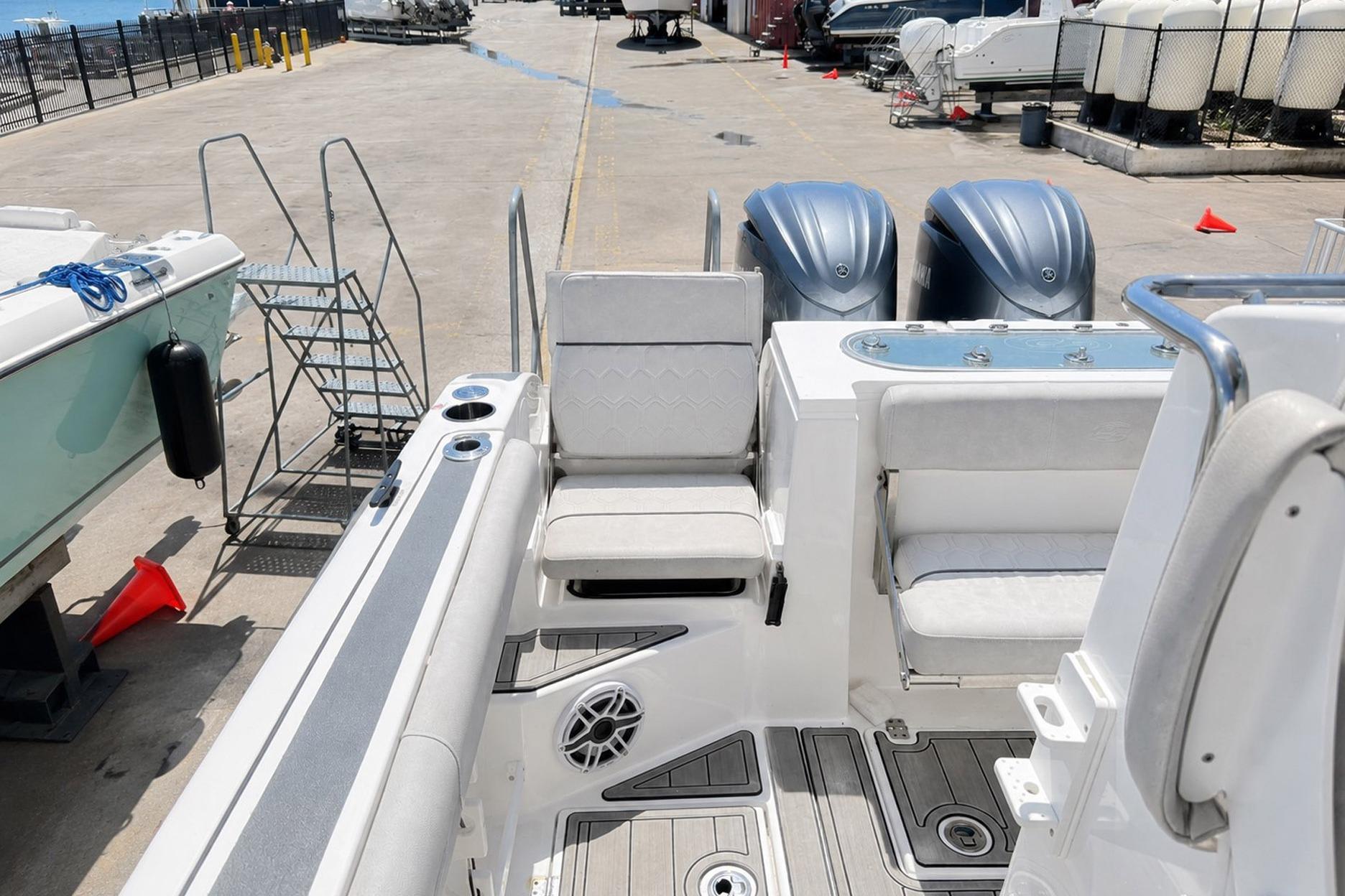 2002 Sea Fox 228 Commander boat with dual engines, docked at a marina.