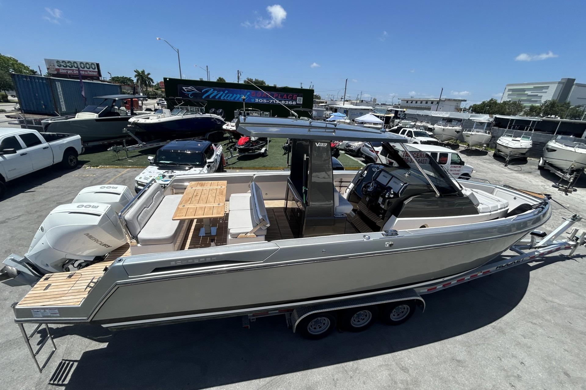 2023 Schaefer V33 boat on trailer, featuring sleek design and dual Mercury engines.
