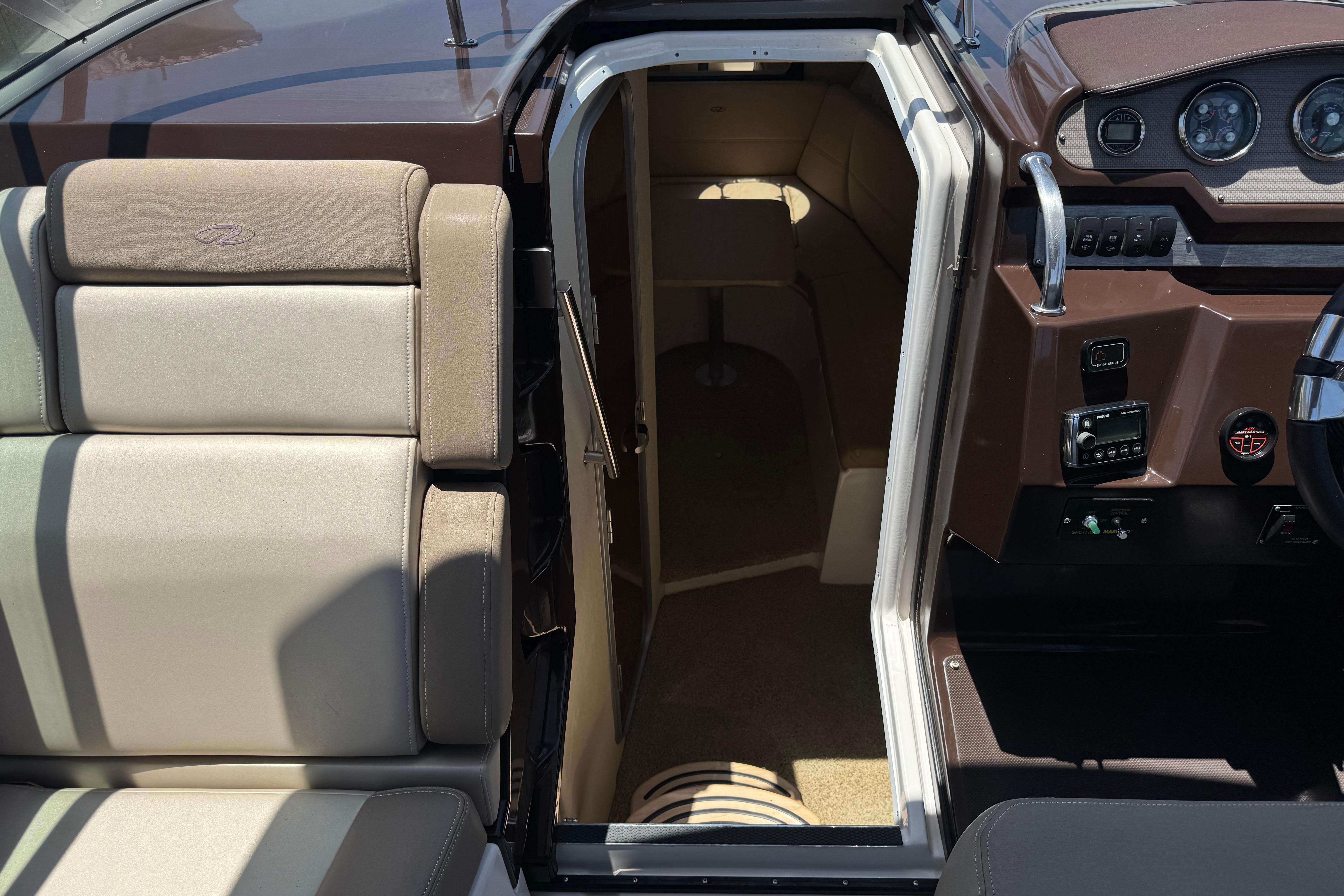 2013 Regal 28 Express boat interior with seating and cabin entrance.