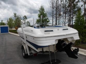 2004 Mariah SK-10 boat on trailer, parked outdoors under cloudy sky.