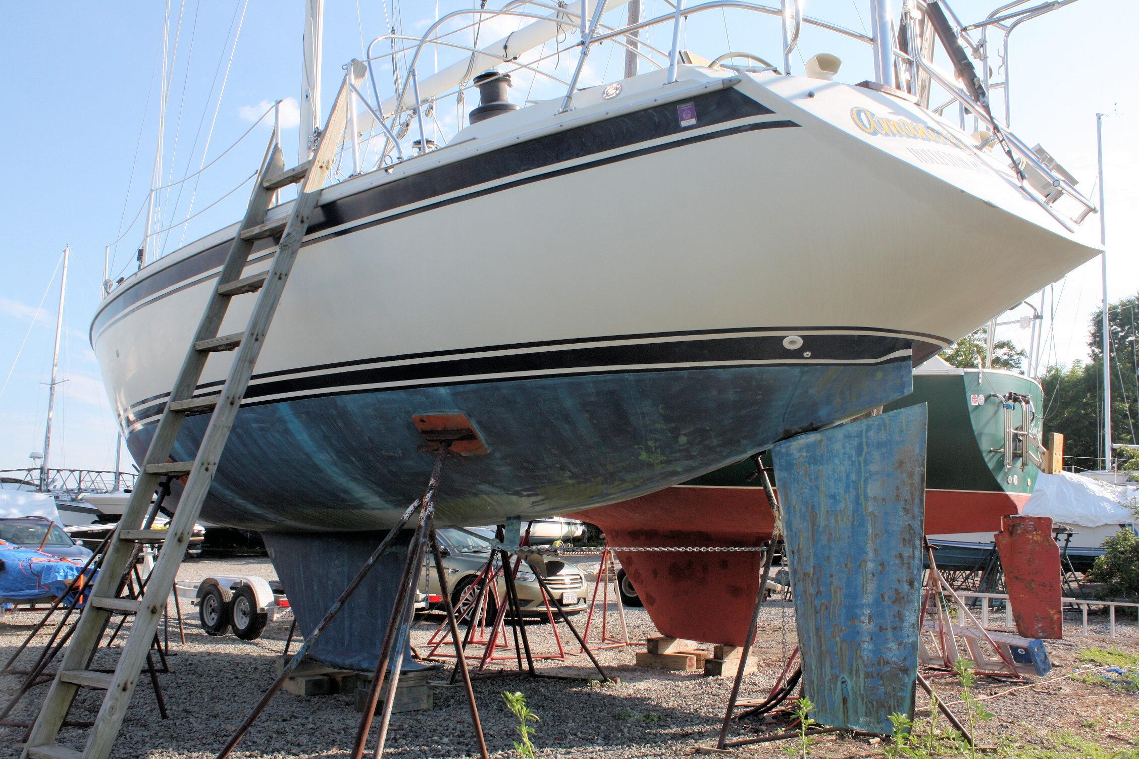 1987 Ericson 38-200 sailboat on dry dock with ladder and support stands.