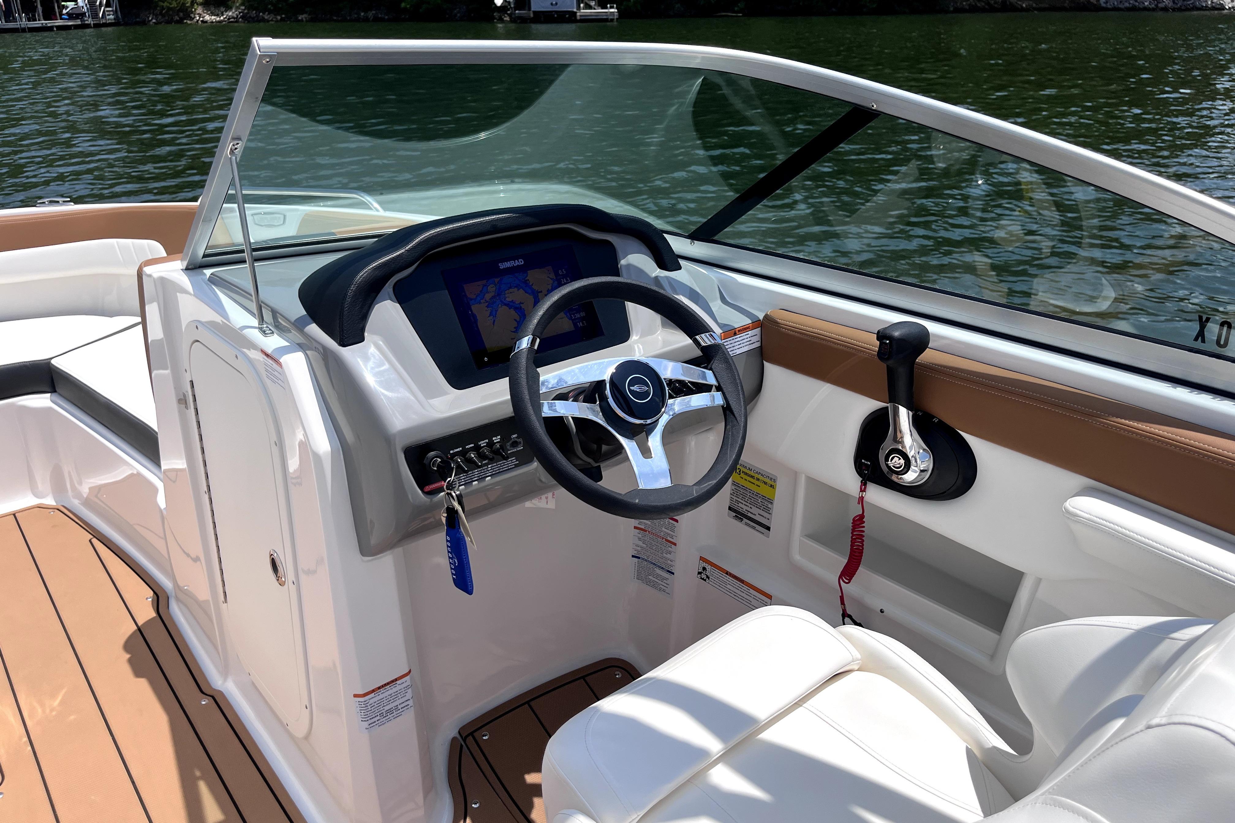 2025 Chaparral 230 SSi boat interior with modern dashboard and steering wheel.
