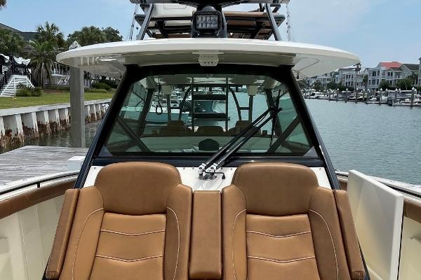 2020 Scout 420 LXF boat with tan seats docked by a marina.