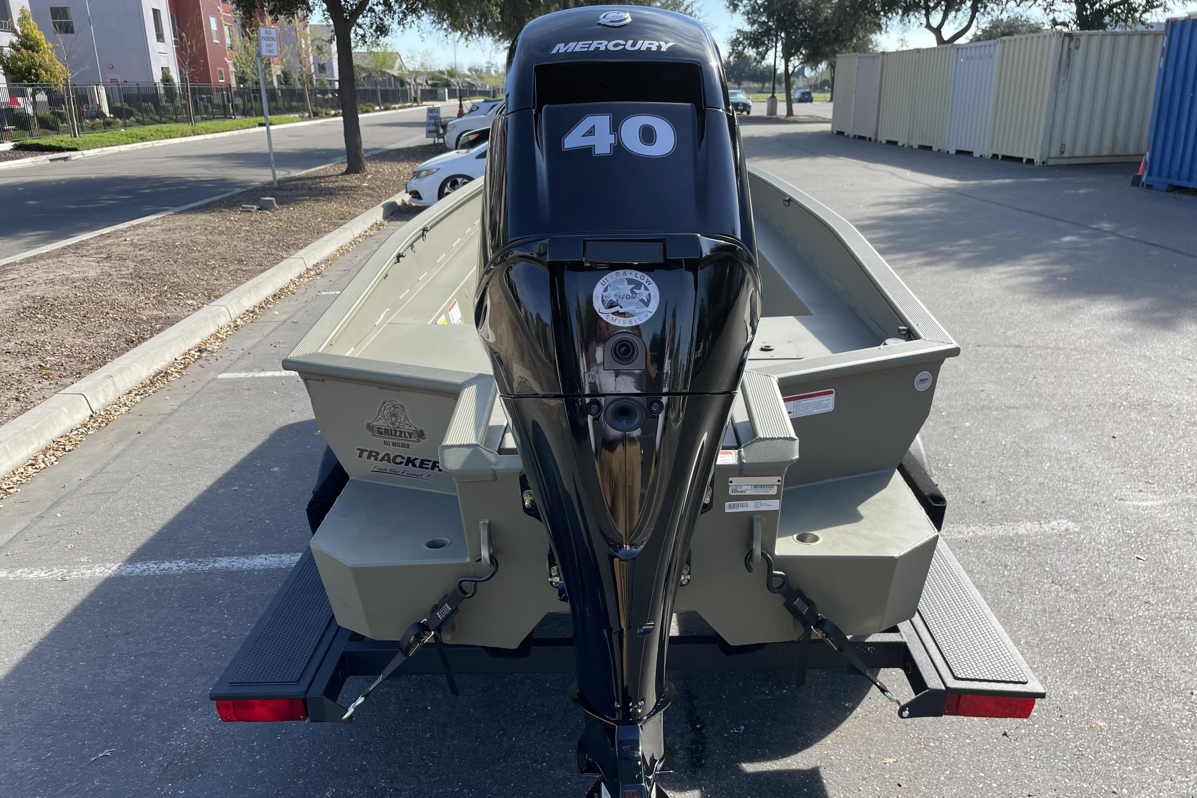 2026 Tracker Grizzly 1650 T Prairie Wings Edition boat with Mercury 40 engine, parked outdoors.