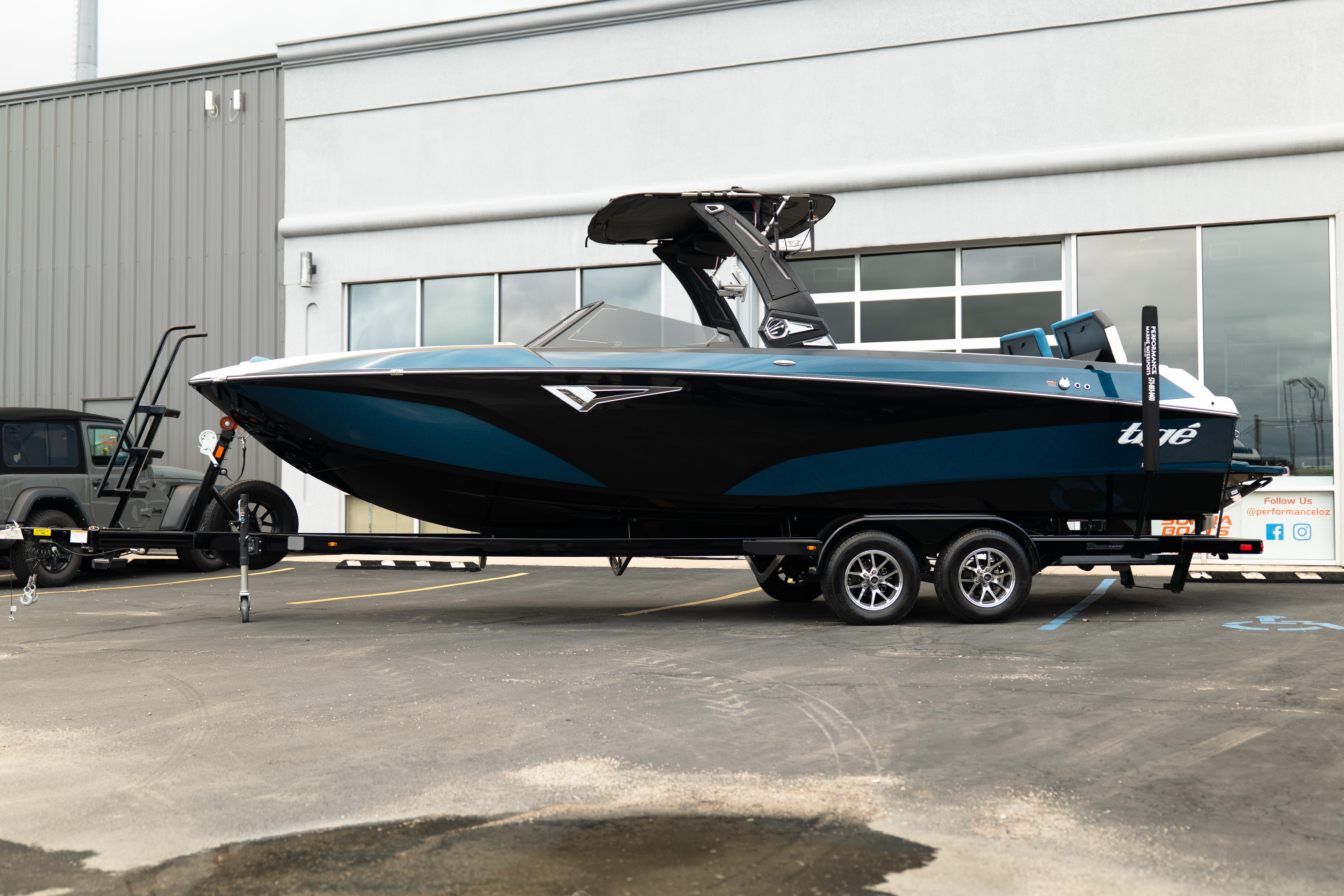 2024 Tigé Z5 boat on trailer, parked outside a modern building.