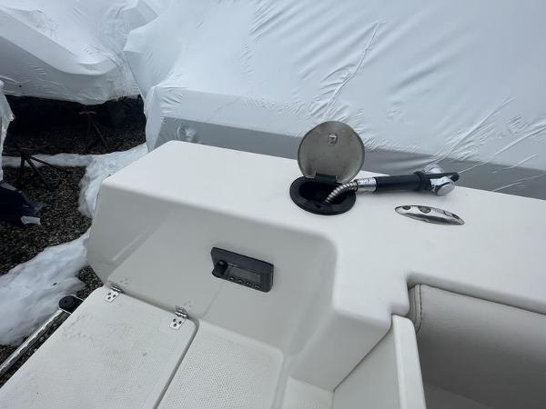 2023 Sailfish 290 CC boat deck with fuel cap and hose.