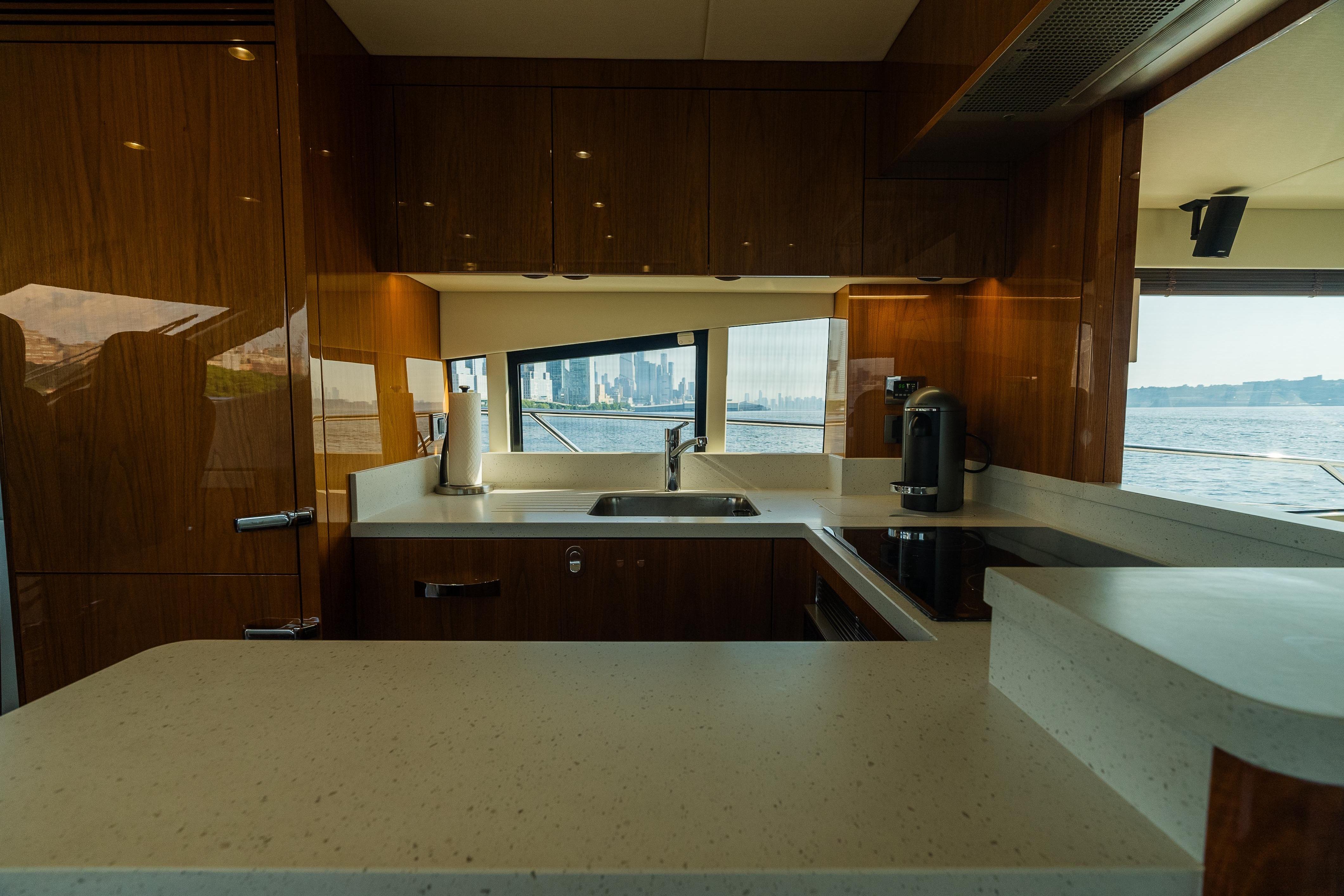 Luxurious kitchen interior of 2016 Sunseeker Manhattan 65 yacht with ocean view.