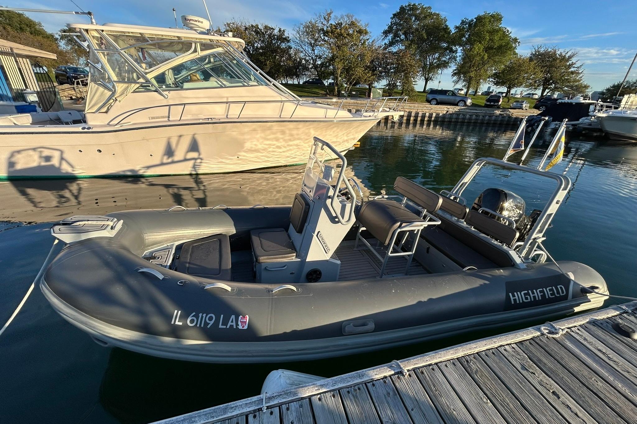 2007 Grady-White Express 360 docked beside a Highfield inflatable boat.