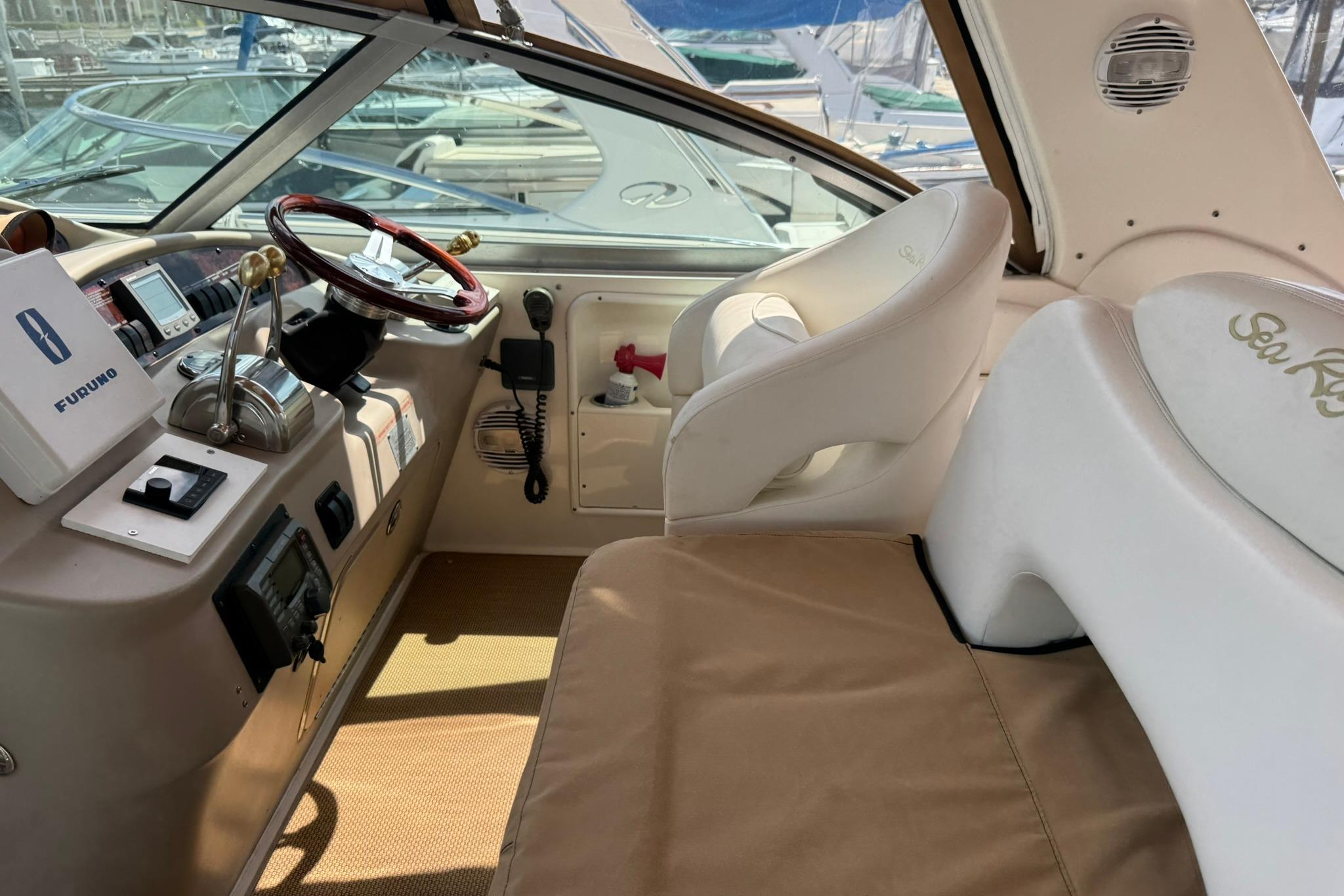 Cockpit of 2001 Sea Ray 340 Sundancer with steering wheel and navigation equipment.