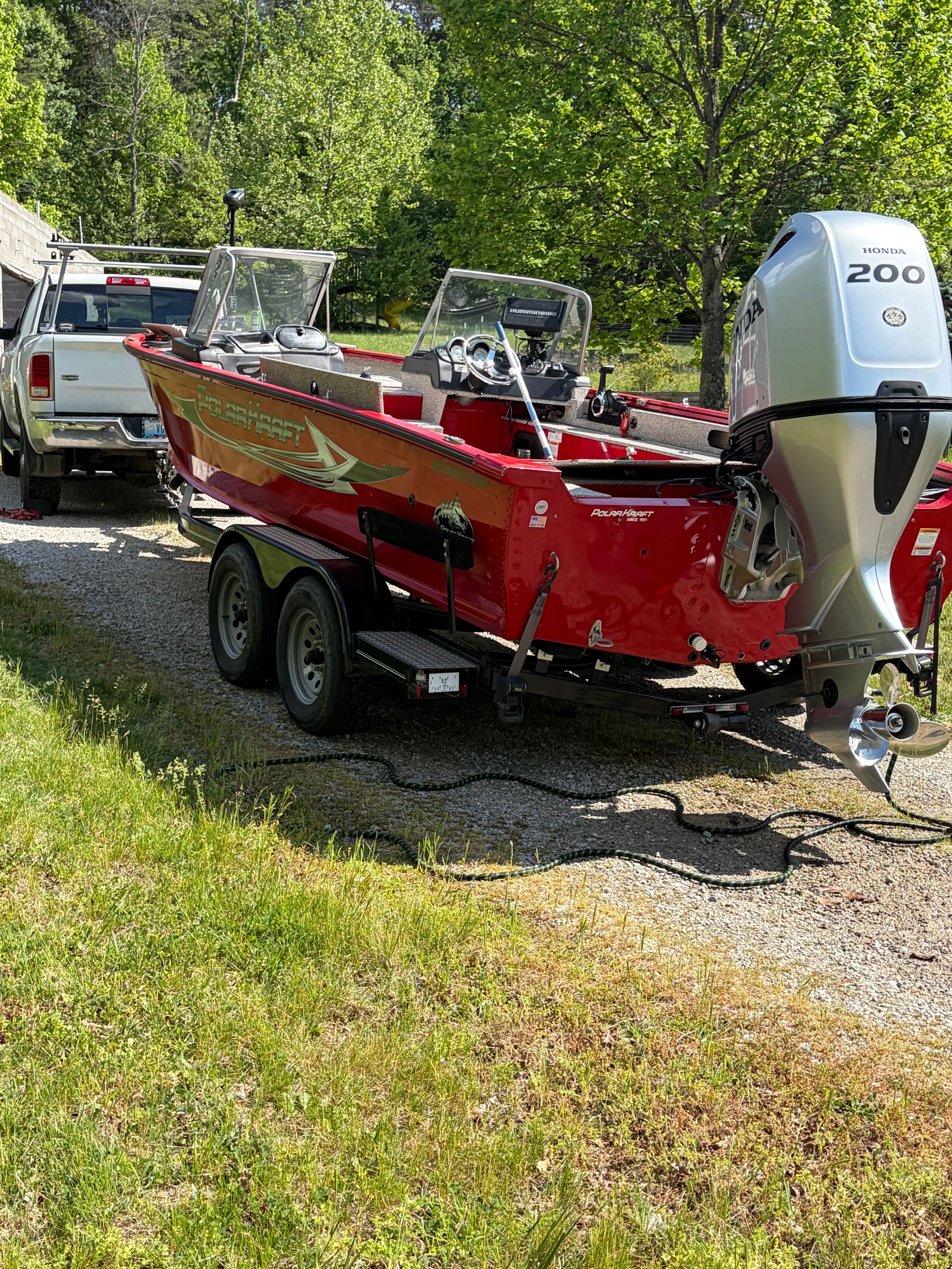 Red Polar Kraft Outlander 2010 boat, 2024 model, with Honda 200 engine.
